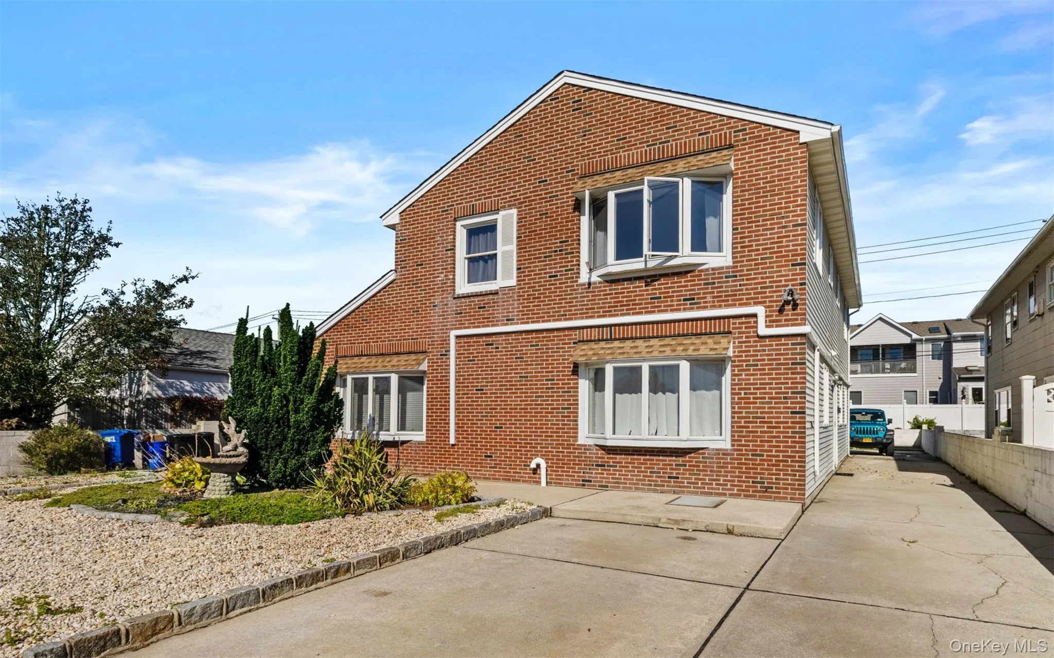 Back of property featuring brick siding Back of property featuring brick siding