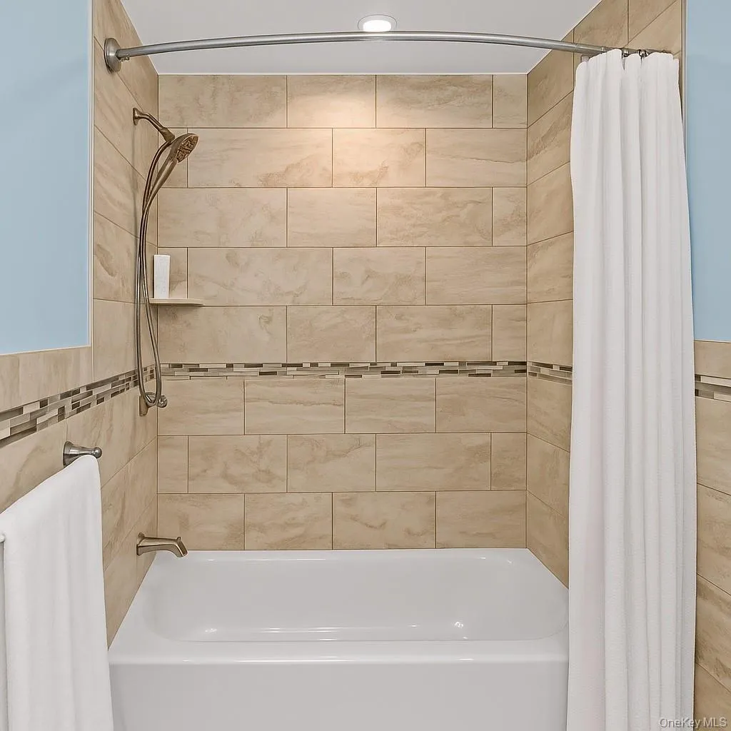 Full bath featuring shower / bath combination with curtain Full bath featuring shower / bath combination with curtain