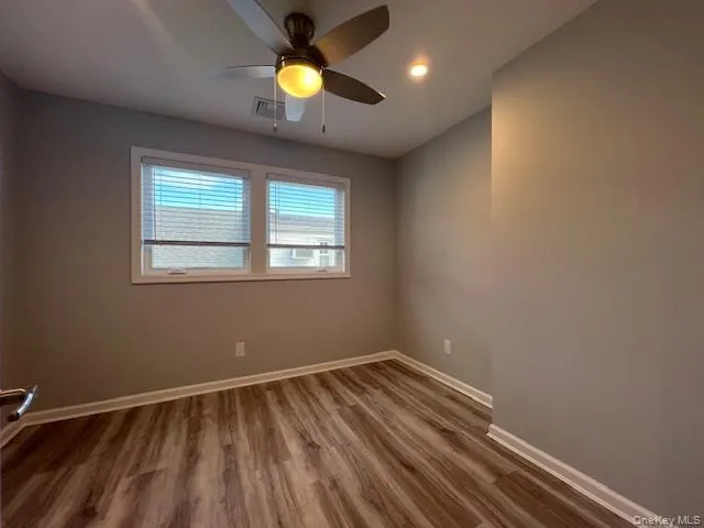 Spare room featuring wood finished floors, a ceiling fan, and recessed lighting Spare room featuring wood finished floors, a ceiling fan, and recessed lighting