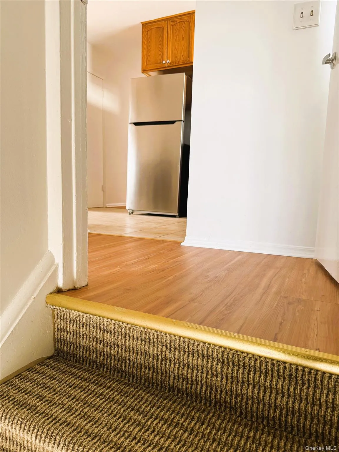 Corridor with light wood-type flooring and baseboards Corridor with light wood-type flooring and baseboards