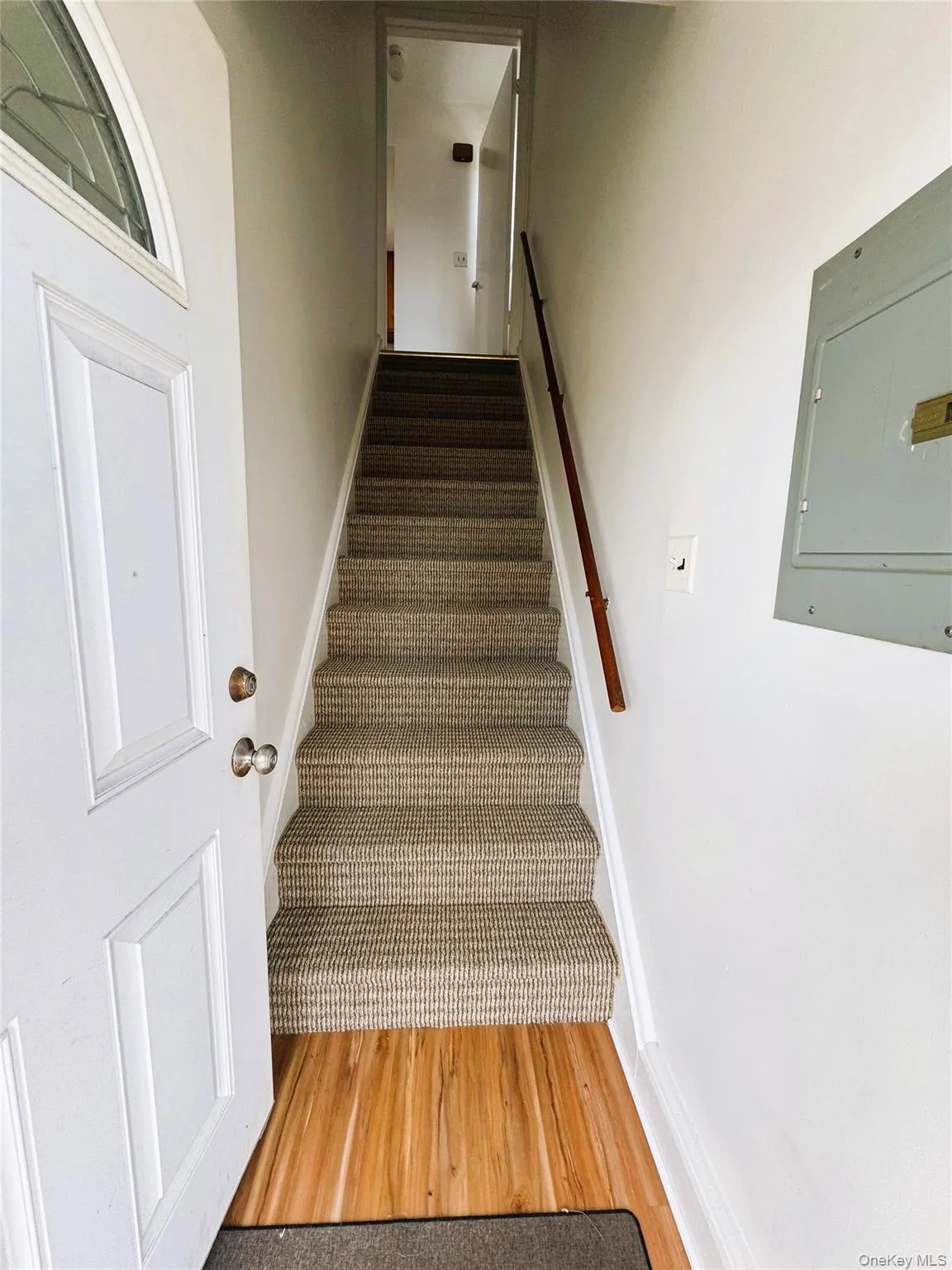 Stairway with electric panel and wood finished floors Stairway with electric panel and wood finished floors