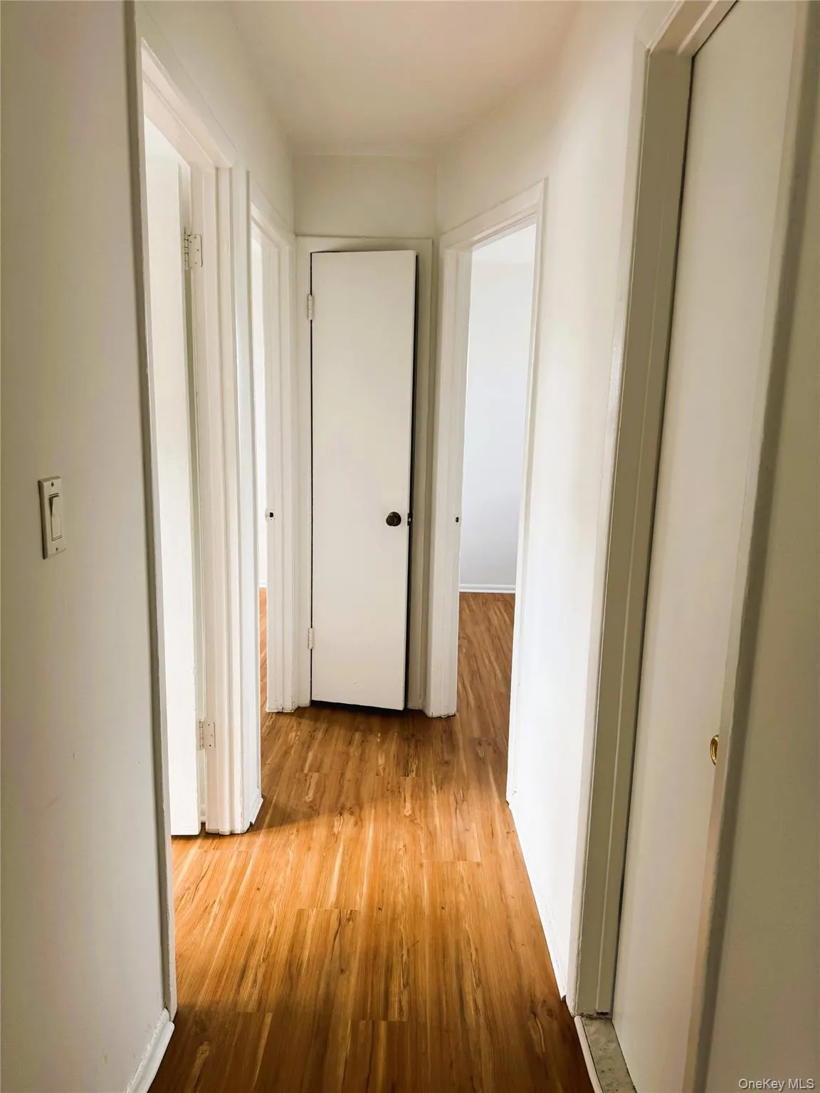 Corridor with light wood finished floors and baseboards Corridor with light wood finished floors and baseboards