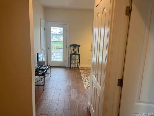 Entryway featuring wood finished floors and baseboards Entryway featuring wood finished floors and baseboards
