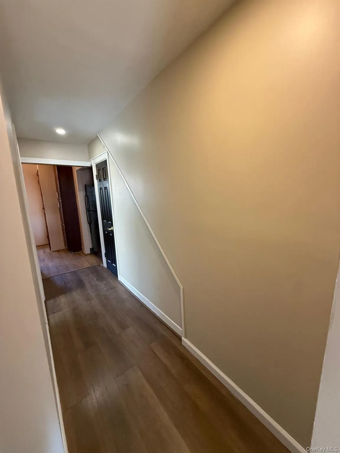 Hall with wood finished floors and baseboards Hall with wood finished floors and baseboards