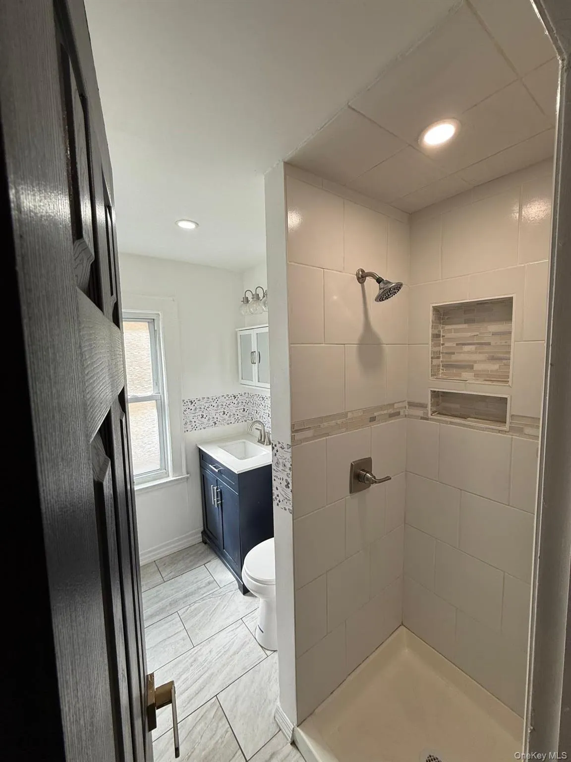 Full bathroom featuring vanity, a stall shower, and recessed lighting Full bathroom featuring vanity, a stall shower, and recessed lighting