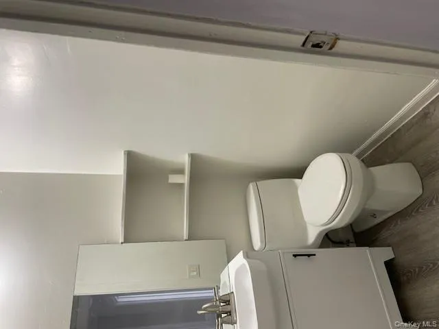 Half bathroom featuring dark wood-style floors and vanity Half bathroom featuring dark wood-style floors and vanity