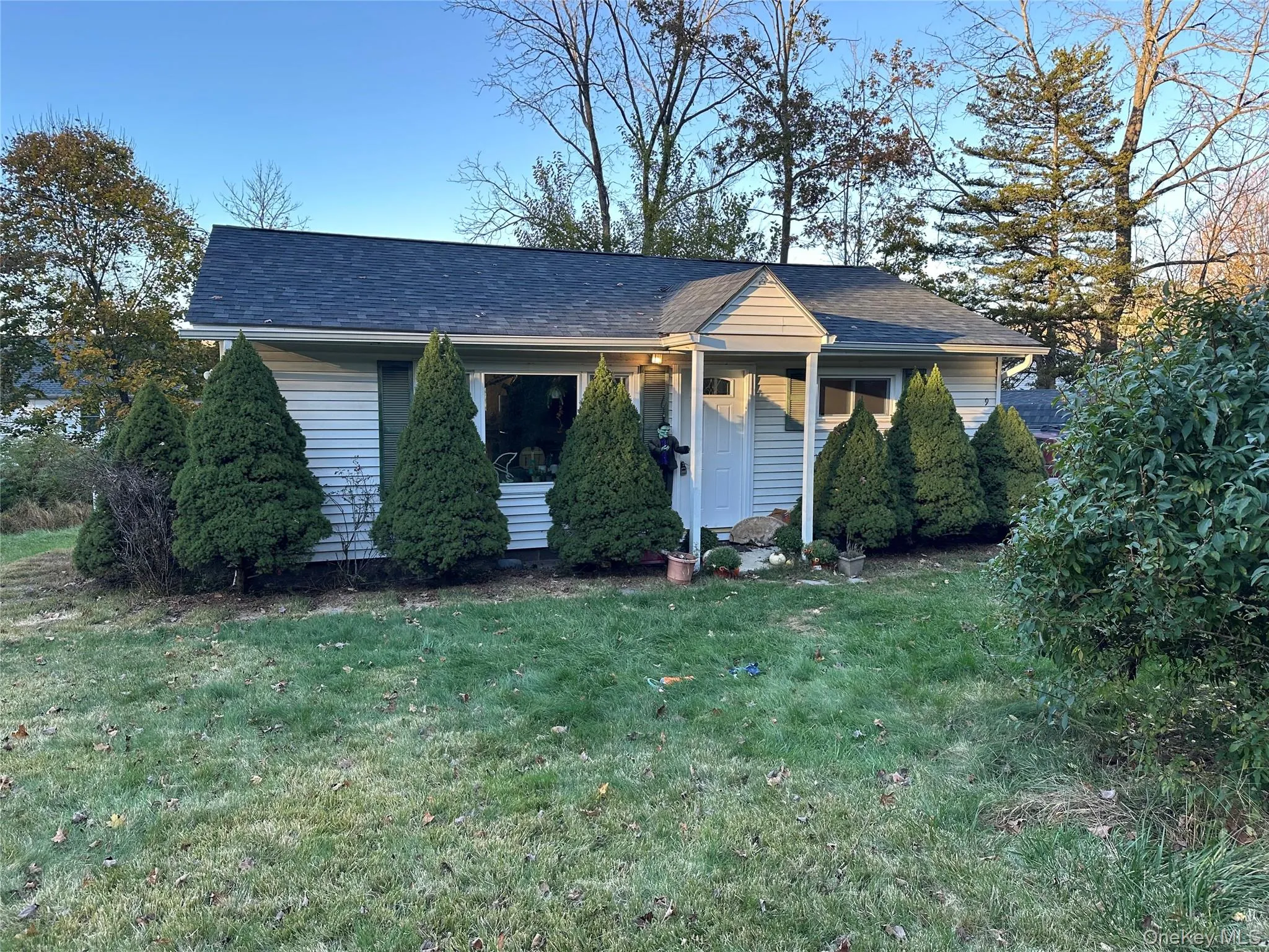 Bungalow featuring a front lawn and a shingled roof Bungalow featuring a front lawn and a shingled roof