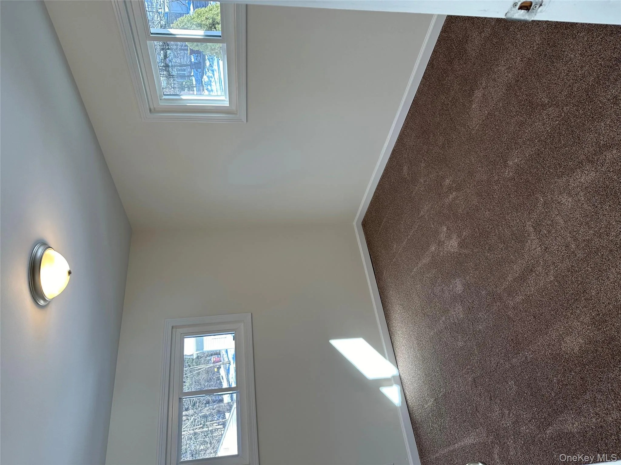 Spare room with healthy amount of natural light and dark colored carpet Spare room with healthy amount of natural light and dark colored carpet