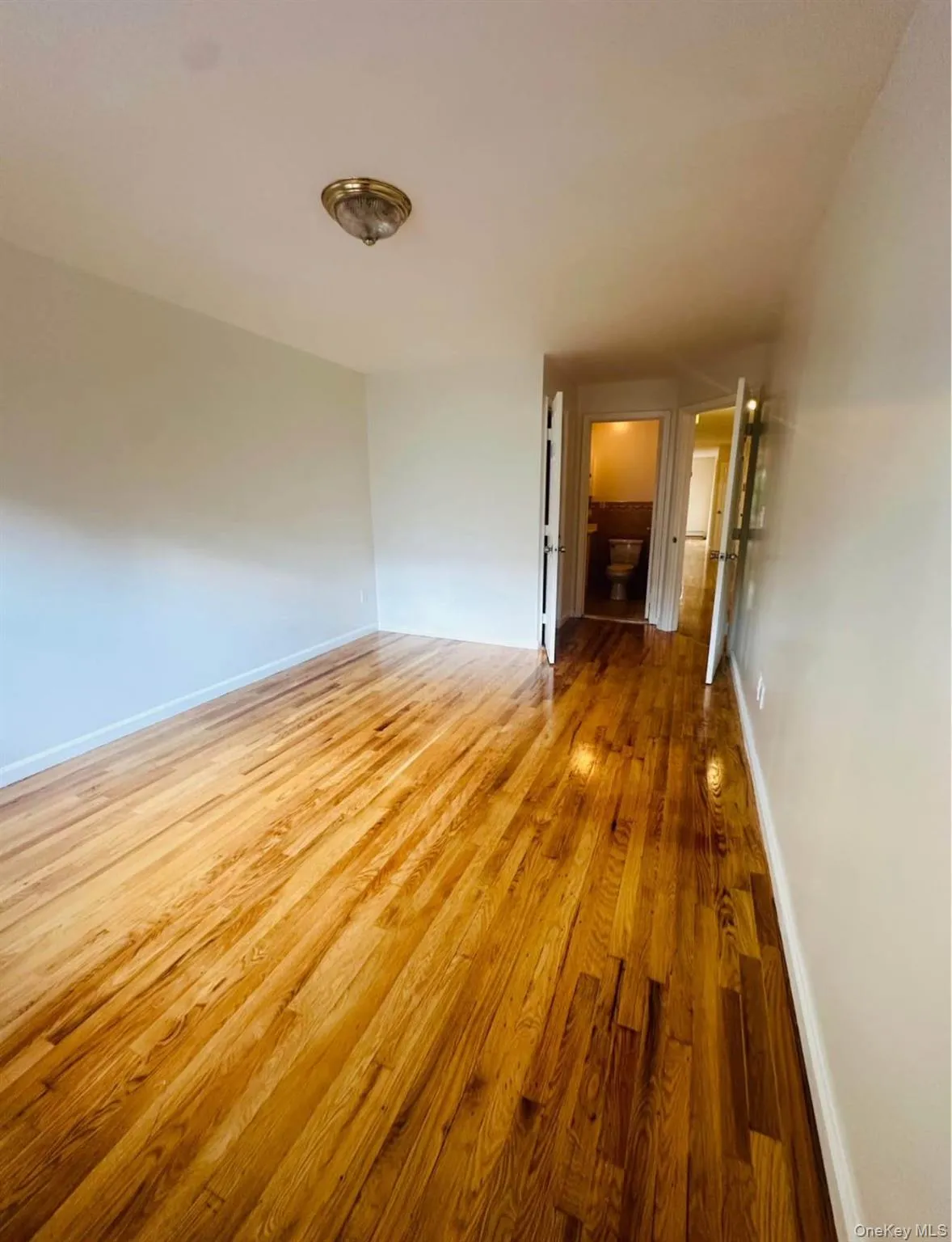 Master bedroom with baseboards and light wood finished floors Master bedroom with baseboards and light wood finished floors