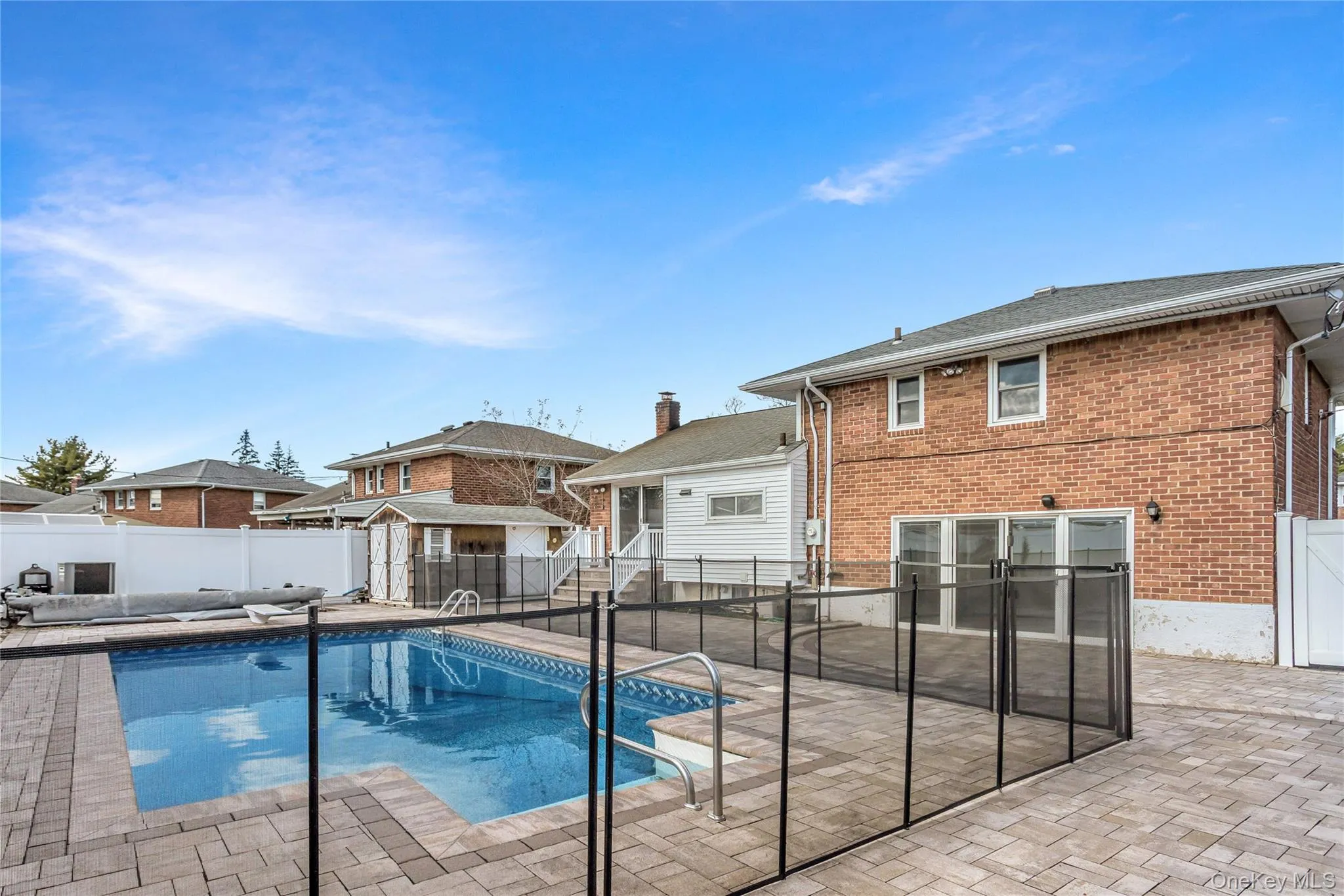 View of swimming pool with a fenced backyard and a patio area View of swimming pool with a fenced backyard and a patio area