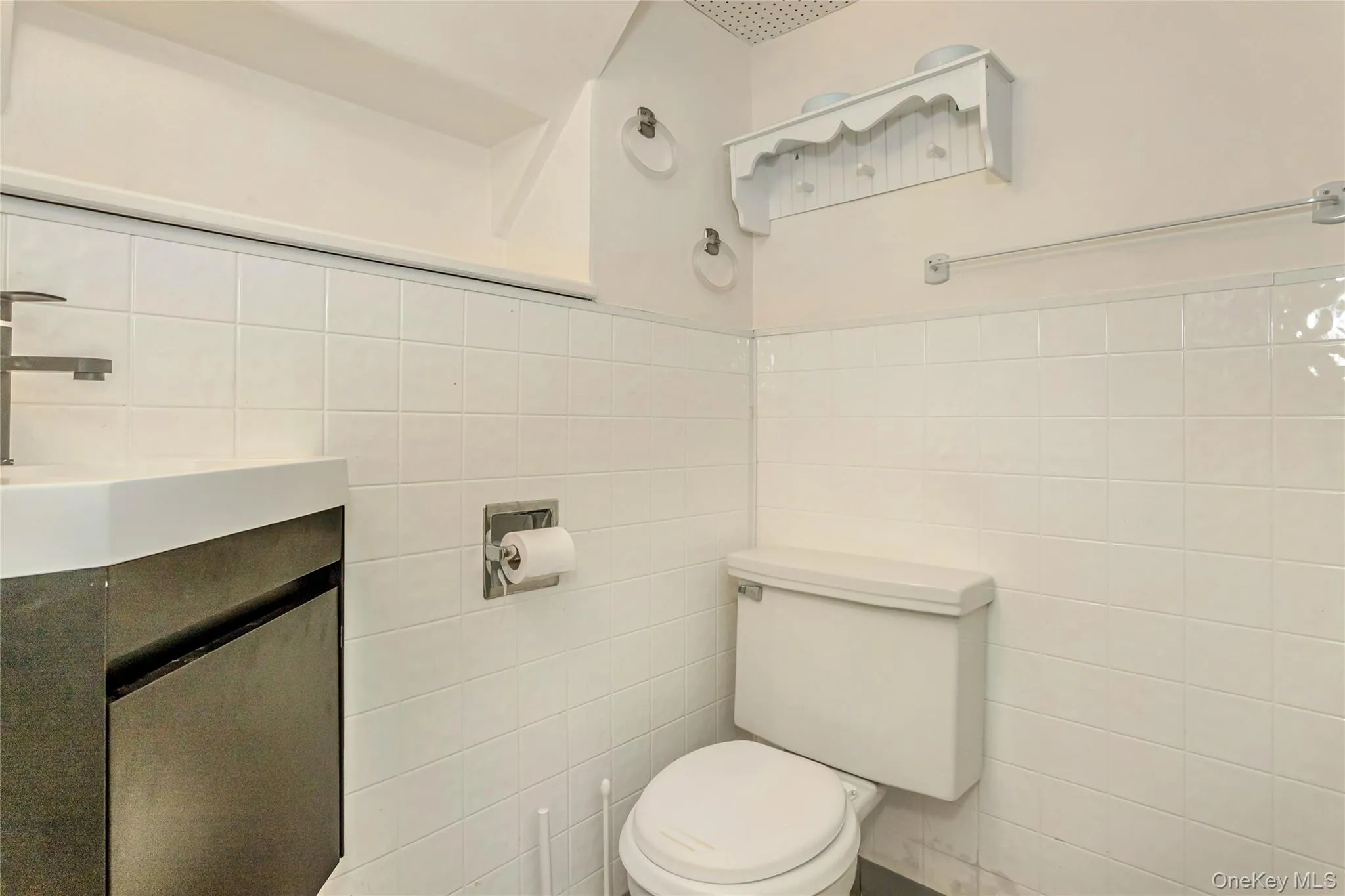 Bathroom with tile walls and vanity Bathroom with tile walls and vanity