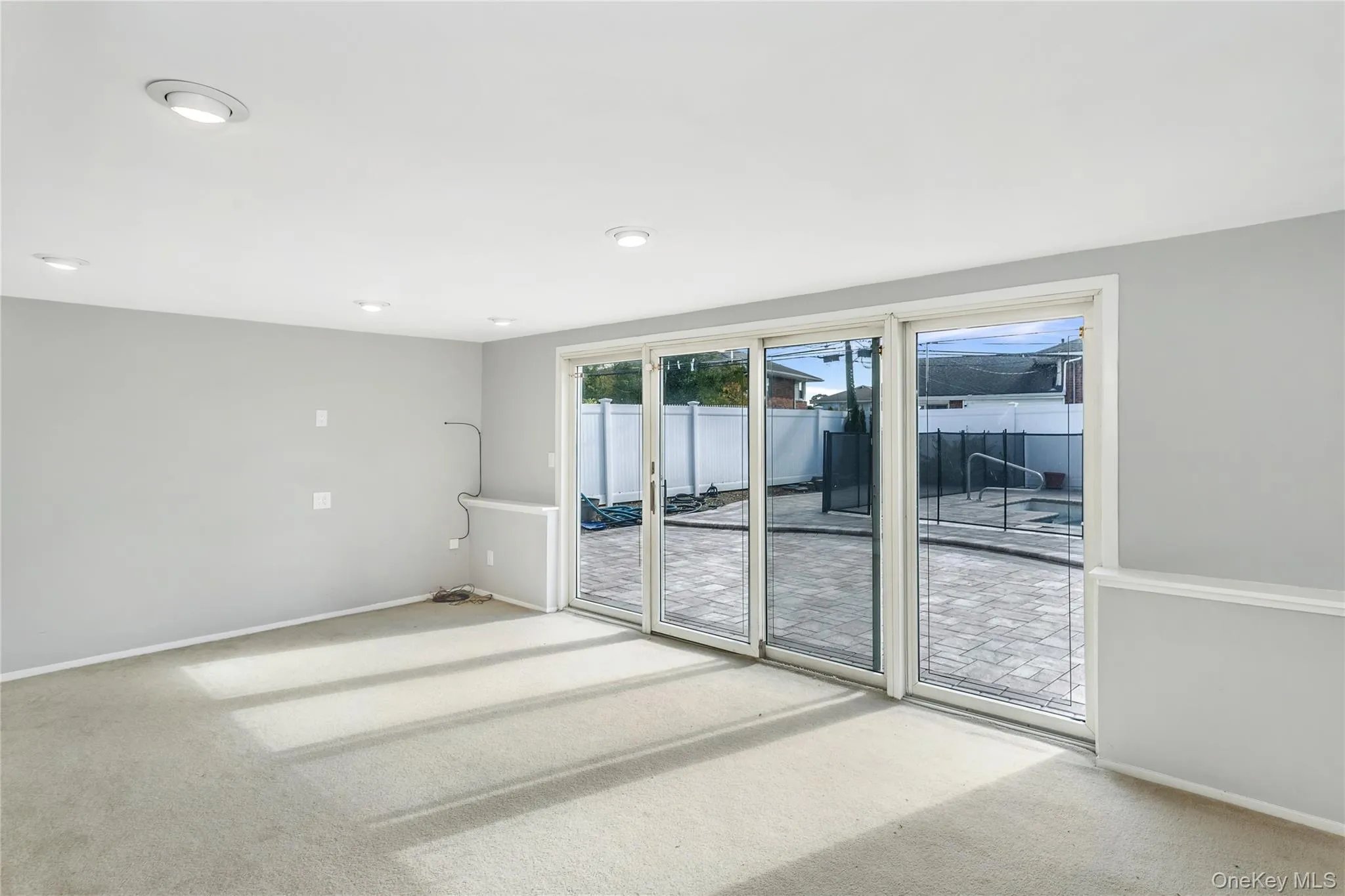 Empty room featuring carpet flooring and baseboards Empty room featuring carpet flooring and baseboards
