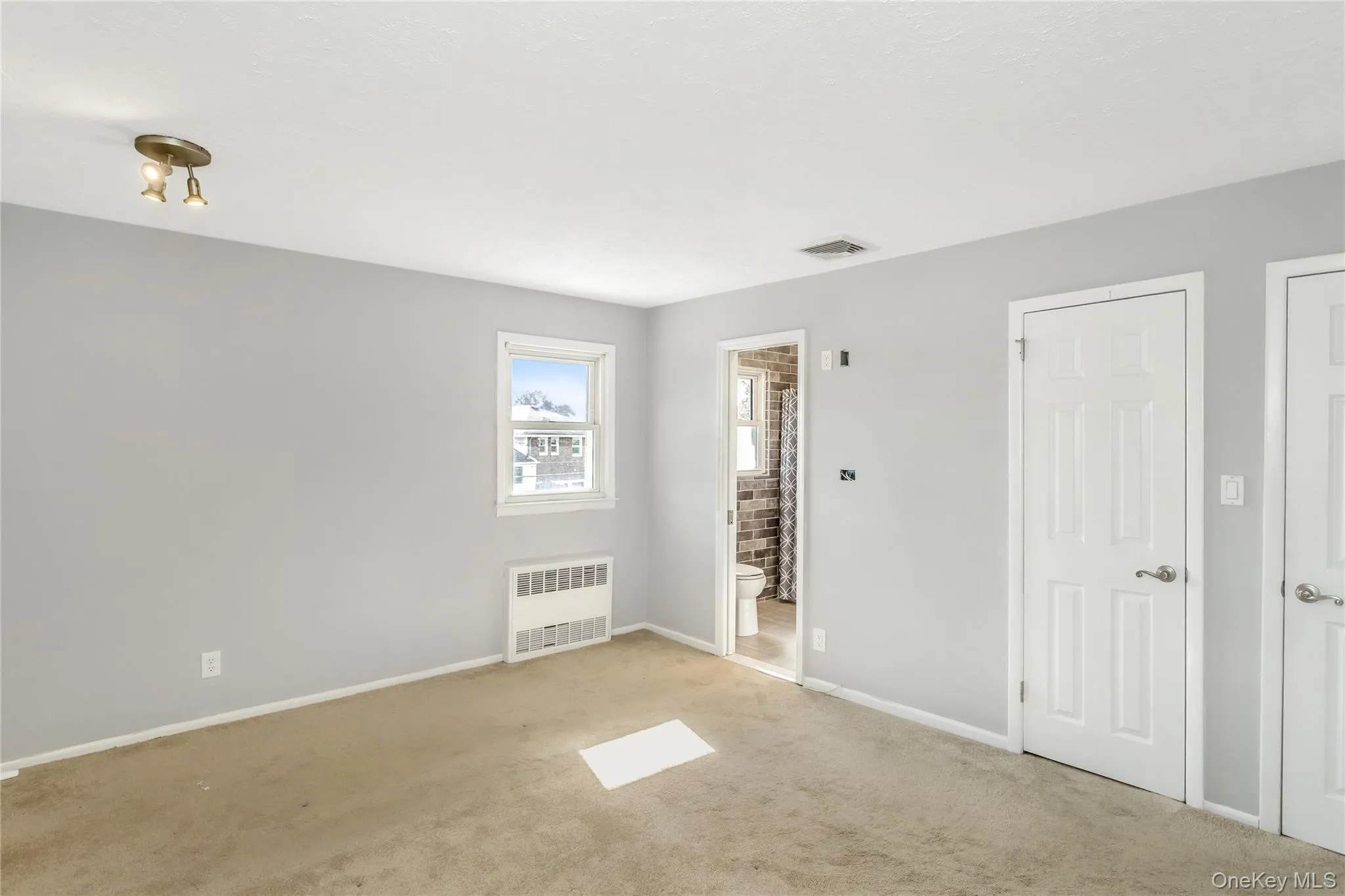 Empty room with carpet and radiator Empty room with carpet and radiator