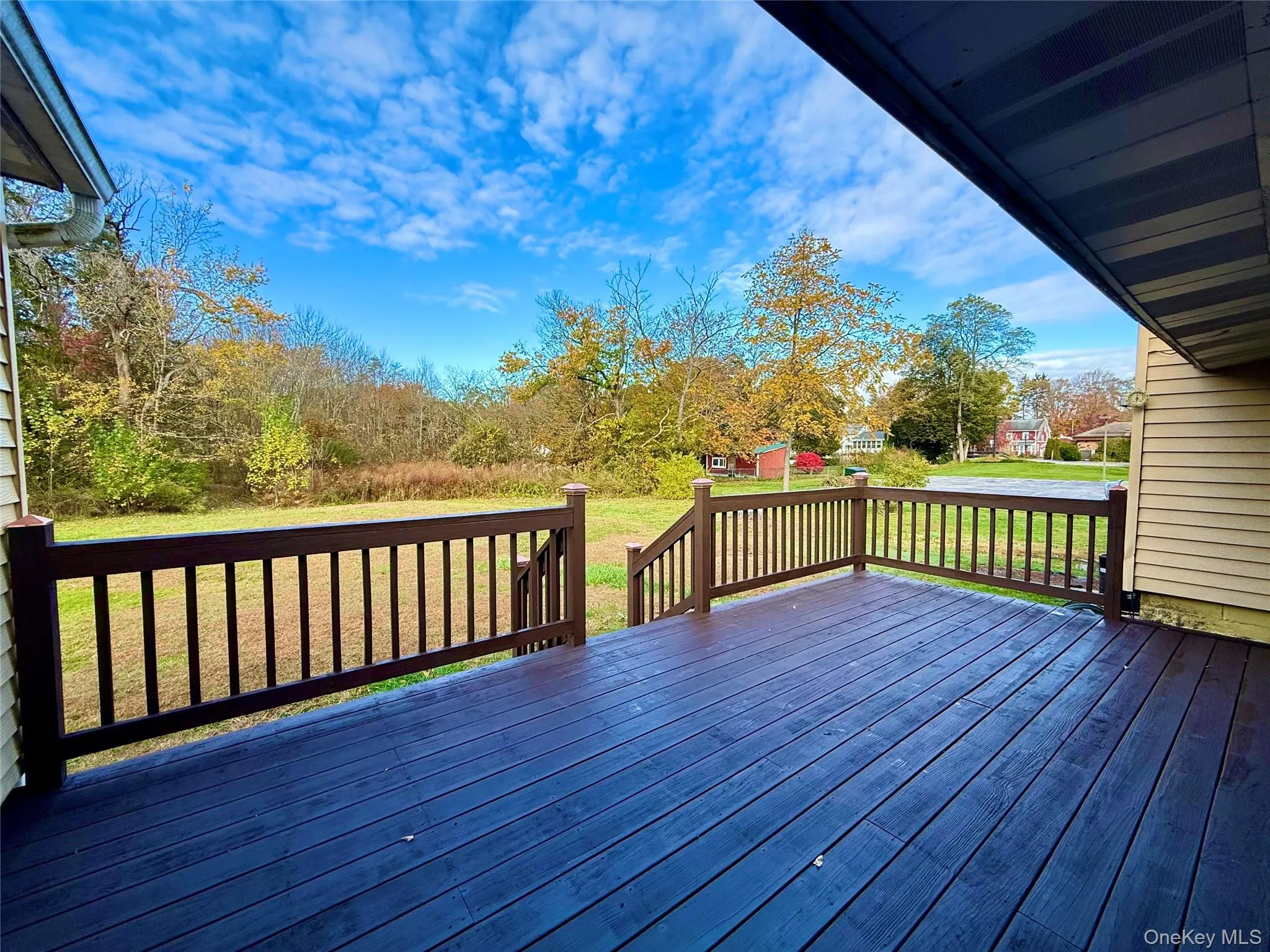 Wooden deck featuring a lawn and a shed Wooden deck featuring a lawn and a shed