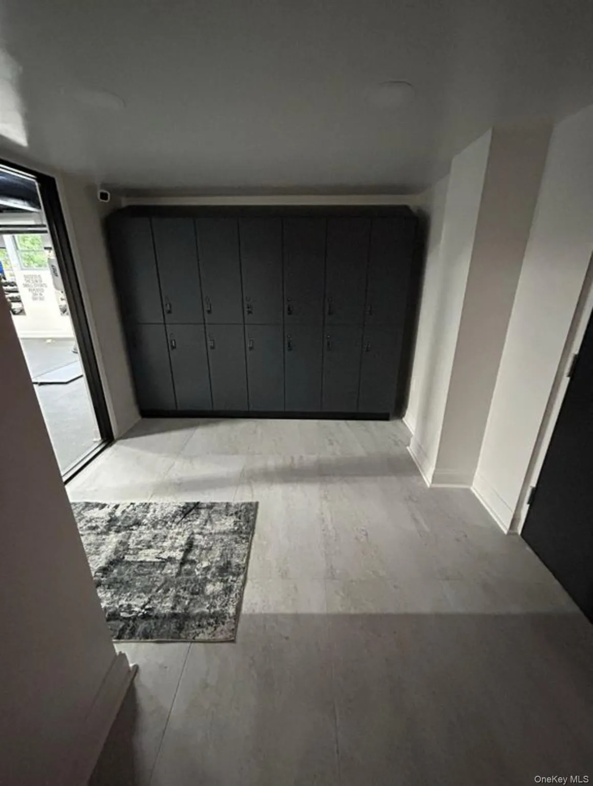 Hall with light hardwood / wood-style floors and a mail area Hall with light hardwood / wood-style floors and a mail area