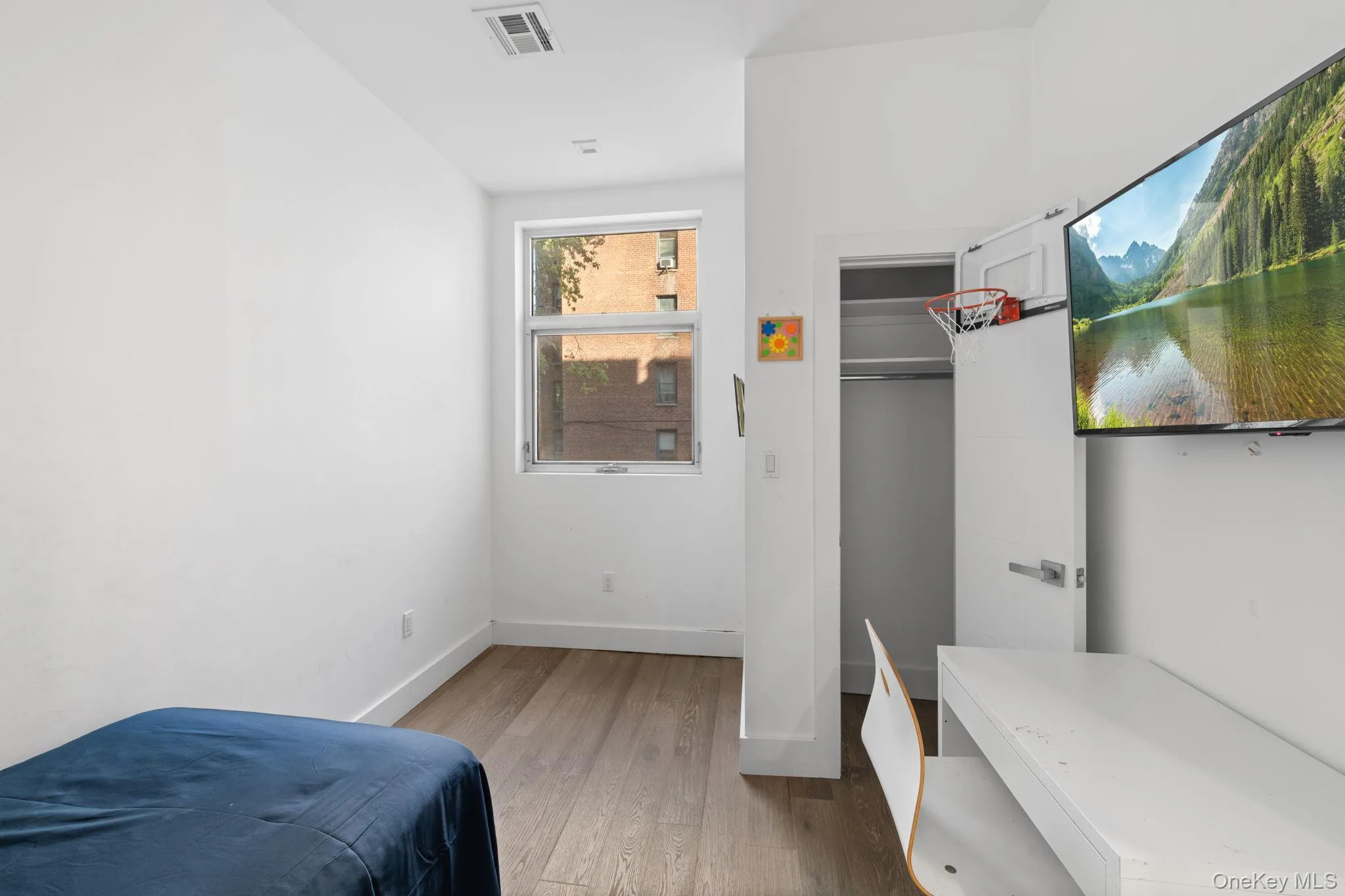 Bedroom featuring hardwood / wood-style floors and baseboards Bedroom featuring hardwood / wood-style floors and baseboards