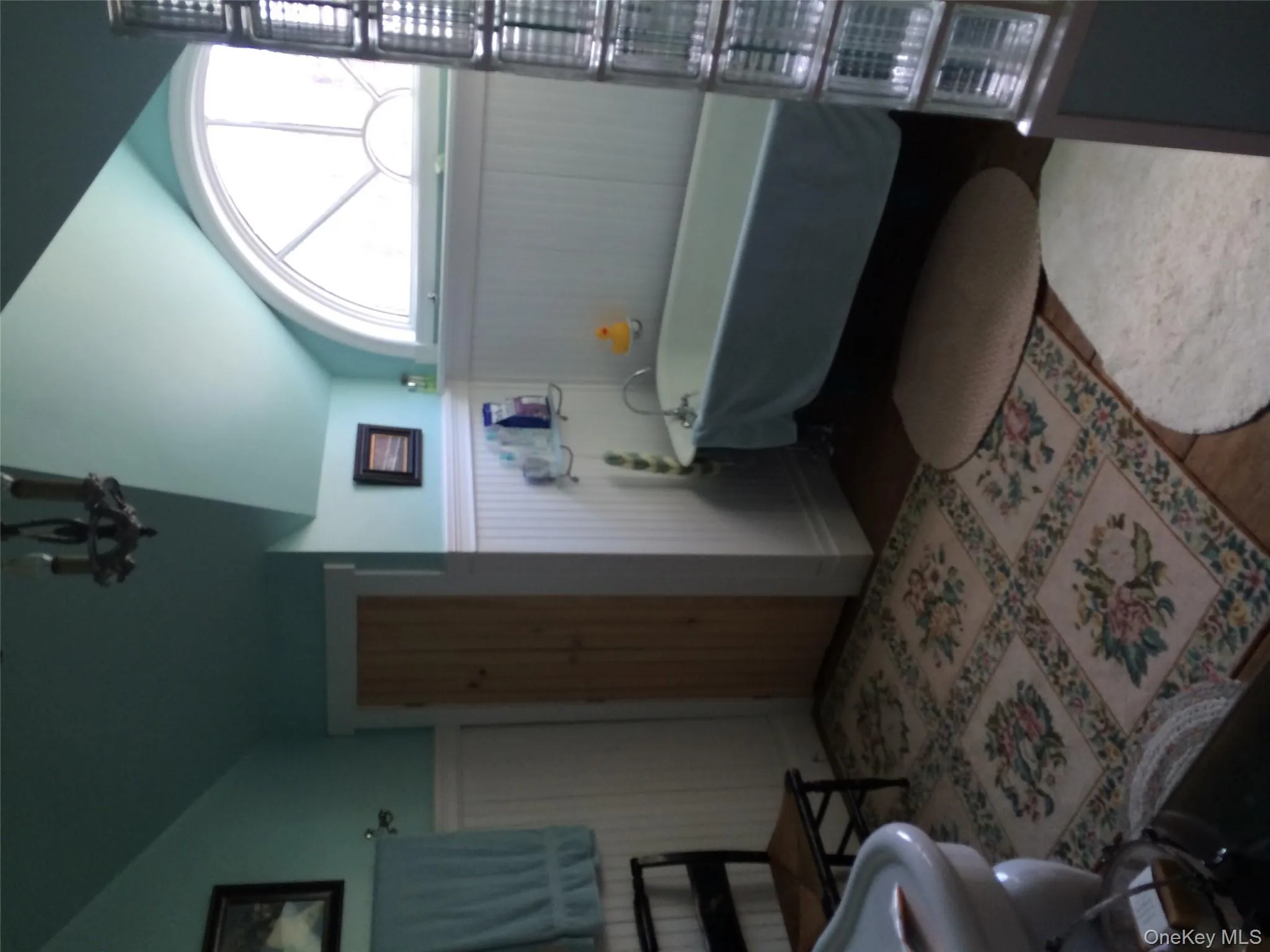 Primary Full bathroom featuring vaulted ceiling, a freestanding bath, wainscoting, and wood finished floors Primary Full bathroom featuring vaulted ceiling, a freestanding bath, wainscoting, and wood finished floors