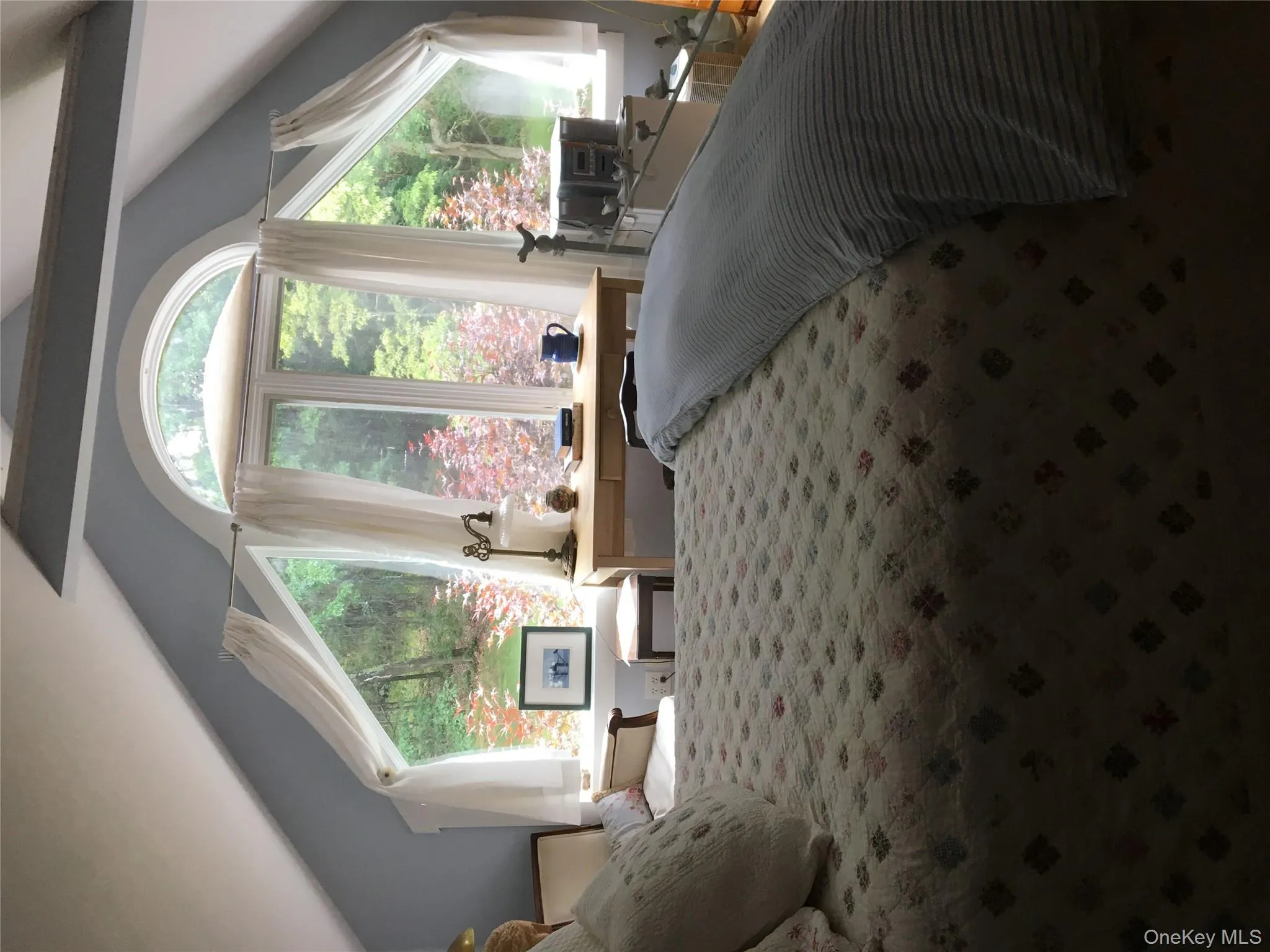 Bedroom above garage featuring multiple windows and lofted ceiling Bedroom above garage featuring multiple windows and lofted ceiling