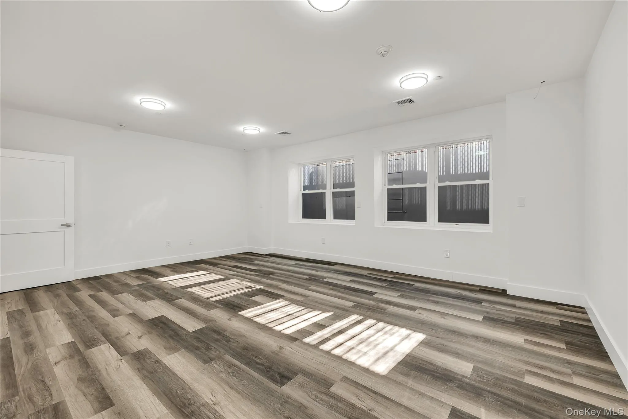 Spare room featuring baseboards and light wood finished floors Spare room featuring baseboards and light wood finished floors