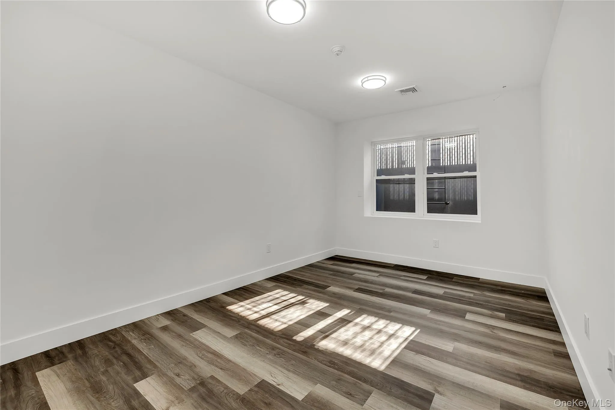 Spare room with wood finished floors Spare room with wood finished floors