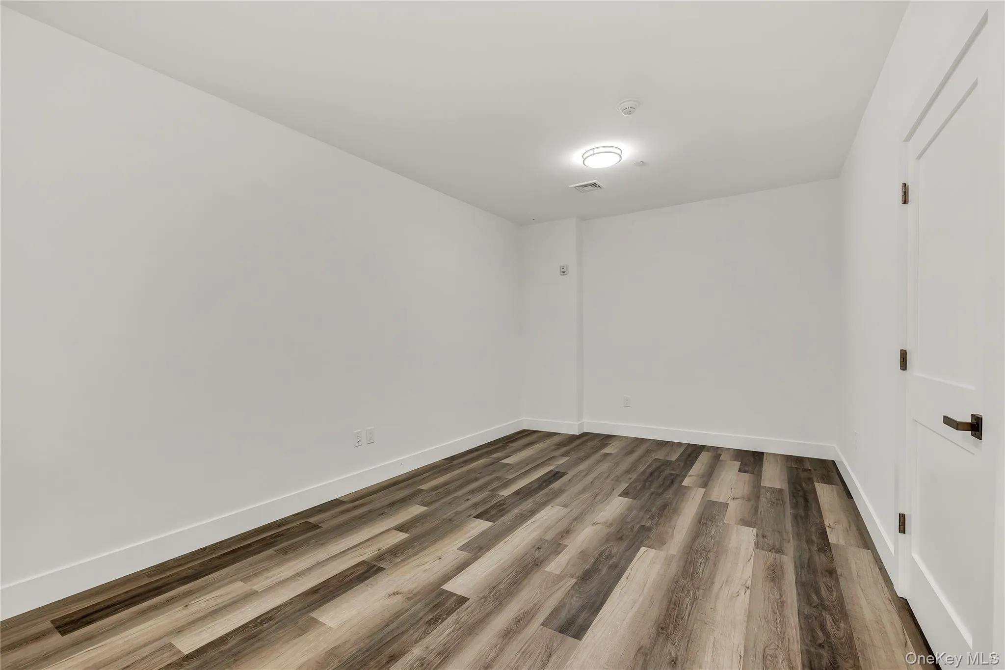 Spare room featuring dark wood finished floors and baseboards Spare room featuring dark wood finished floors and baseboards