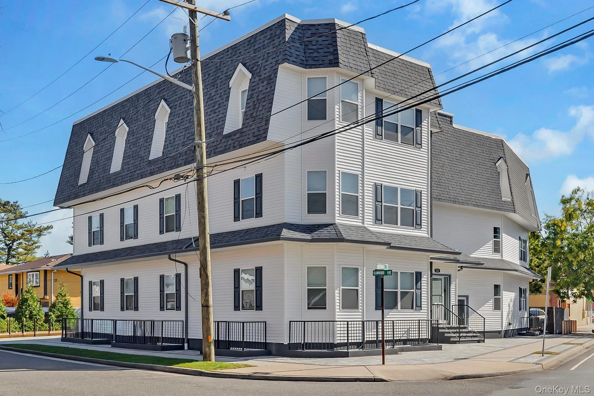 View of home's exterior with mansard roof and roof with shingles View of home's exterior with mansard roof and roof with shingles