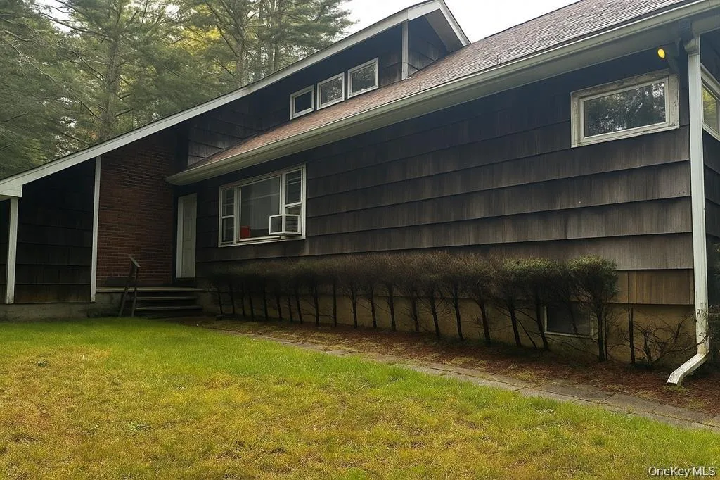 View of home's exterior with a yard and roof with shingles View of home's exterior with a yard and roof with shingles