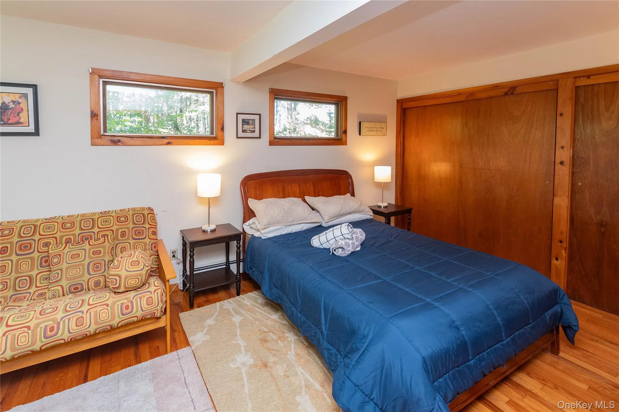 Bedroom featuring wood finished floors and a closet Bedroom featuring wood finished floors and a closet