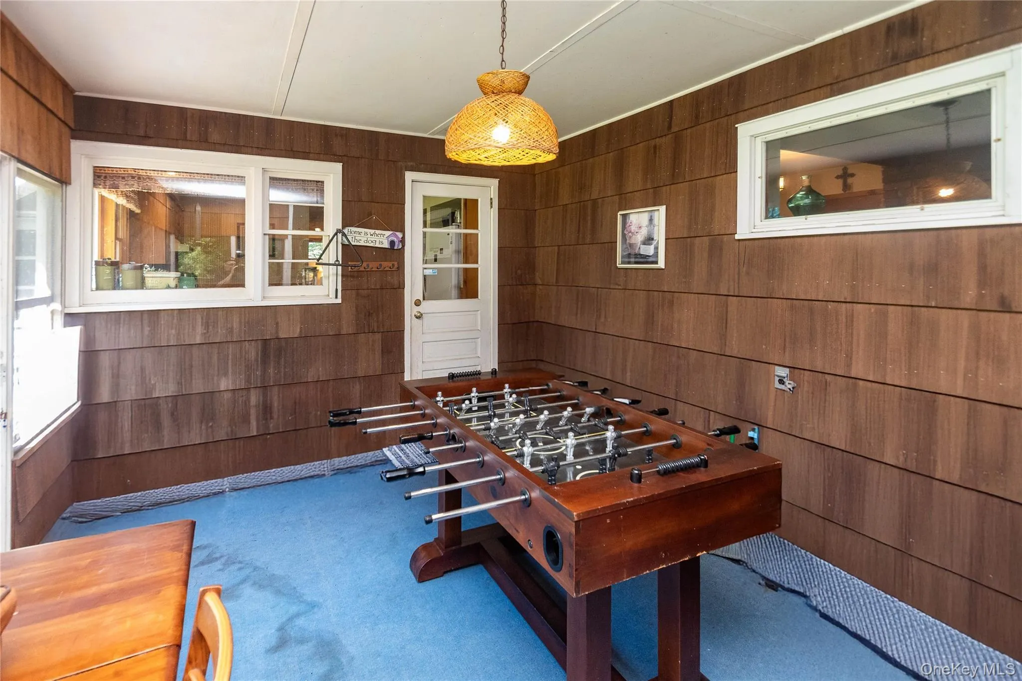Playroom featuring wood walls and carpet Playroom featuring wood walls and carpet
