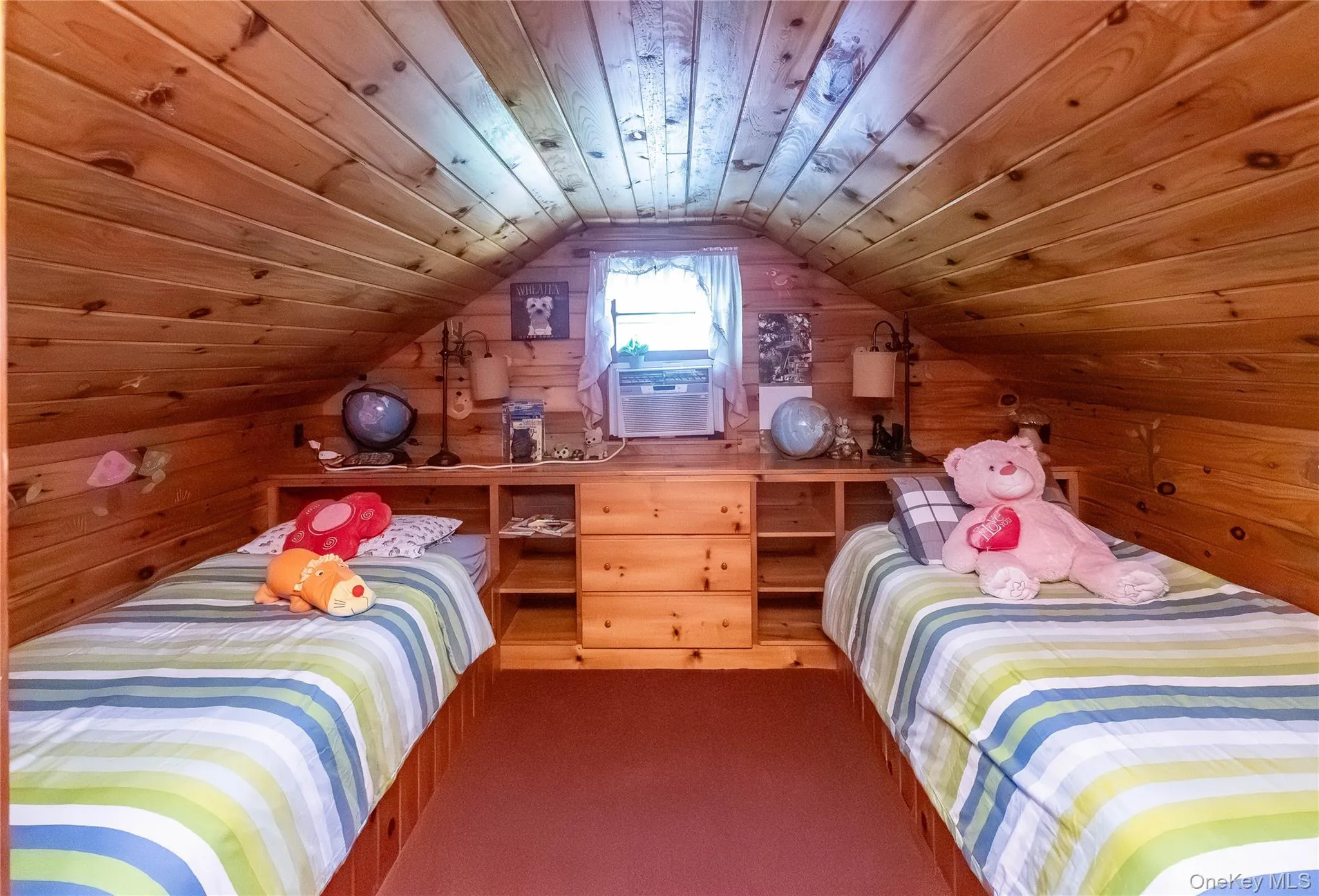 Bedroom featuring wooden ceiling, wooden walls, lofted ceiling, and dark colored carpet Bedroom featuring wooden ceiling, wooden walls, lofted ceiling, and dark colored carpet
