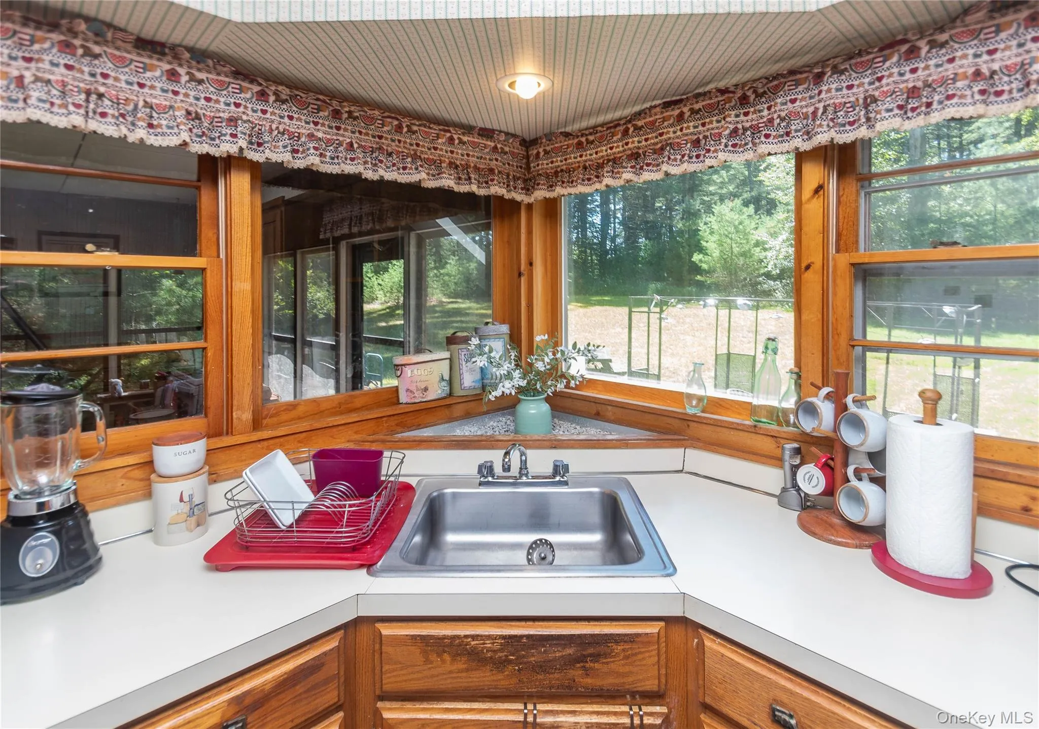 Kitchen featuring light countertops and brown cabinets Kitchen featuring light countertops and brown cabinets
