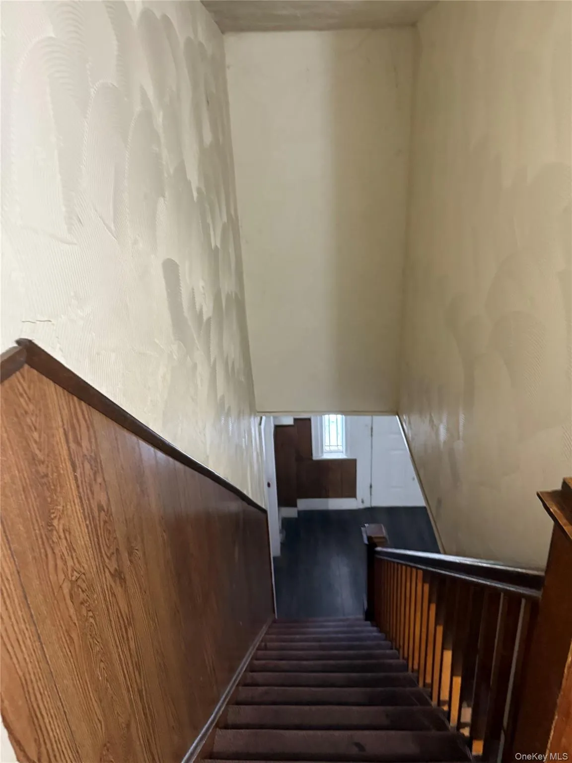 Staircase featuring wood finished floors and a high ceiling Staircase featuring wood finished floors and a high ceiling