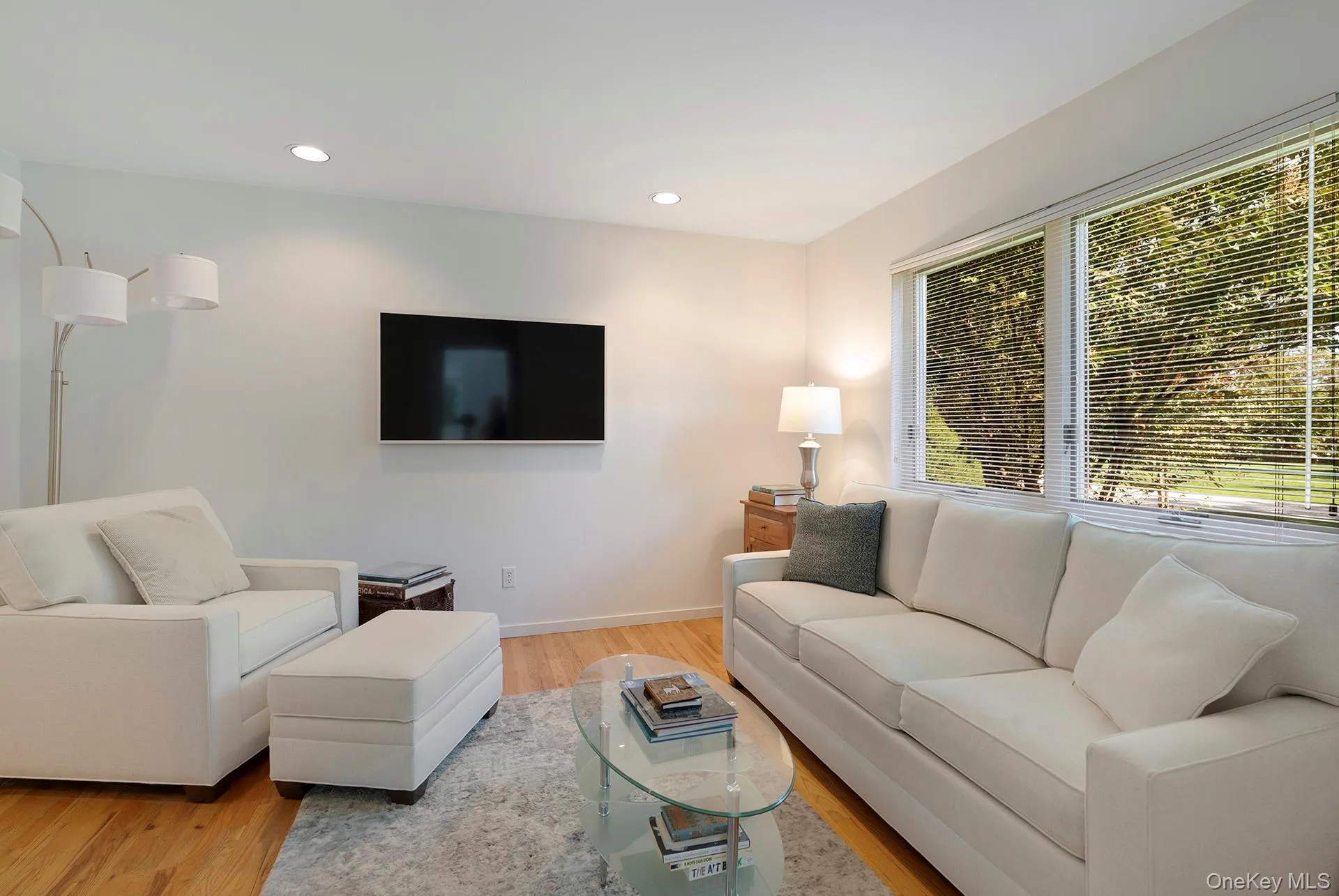 Living room with recessed lighting and light wood finished floors Living room with recessed lighting and light wood finished floors