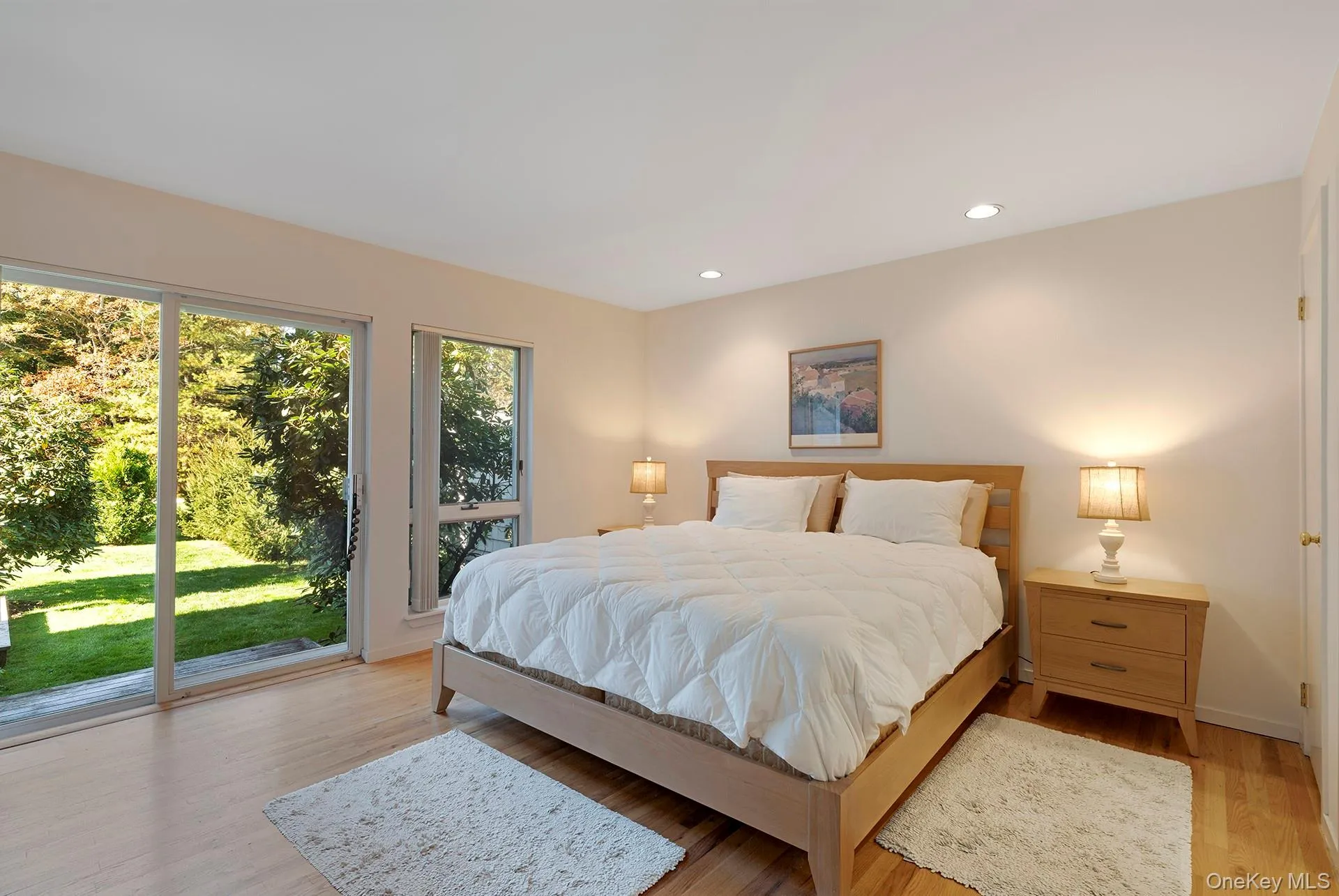 Bedroom with access to exterior, light wood-style flooring, and recessed lighting Bedroom with access to exterior, light wood-style flooring, and recessed lighting