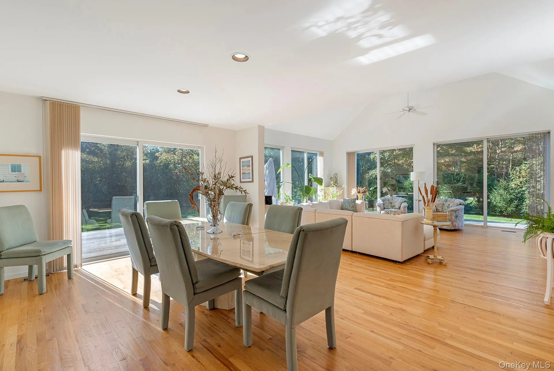 Dining room featuring light wood-style flooring, vaulted ceiling, recessed lighting, and ceiling fan Dining room featuring light wood-style flooring, vaulted ceiling, recessed lighting, and ceiling fan