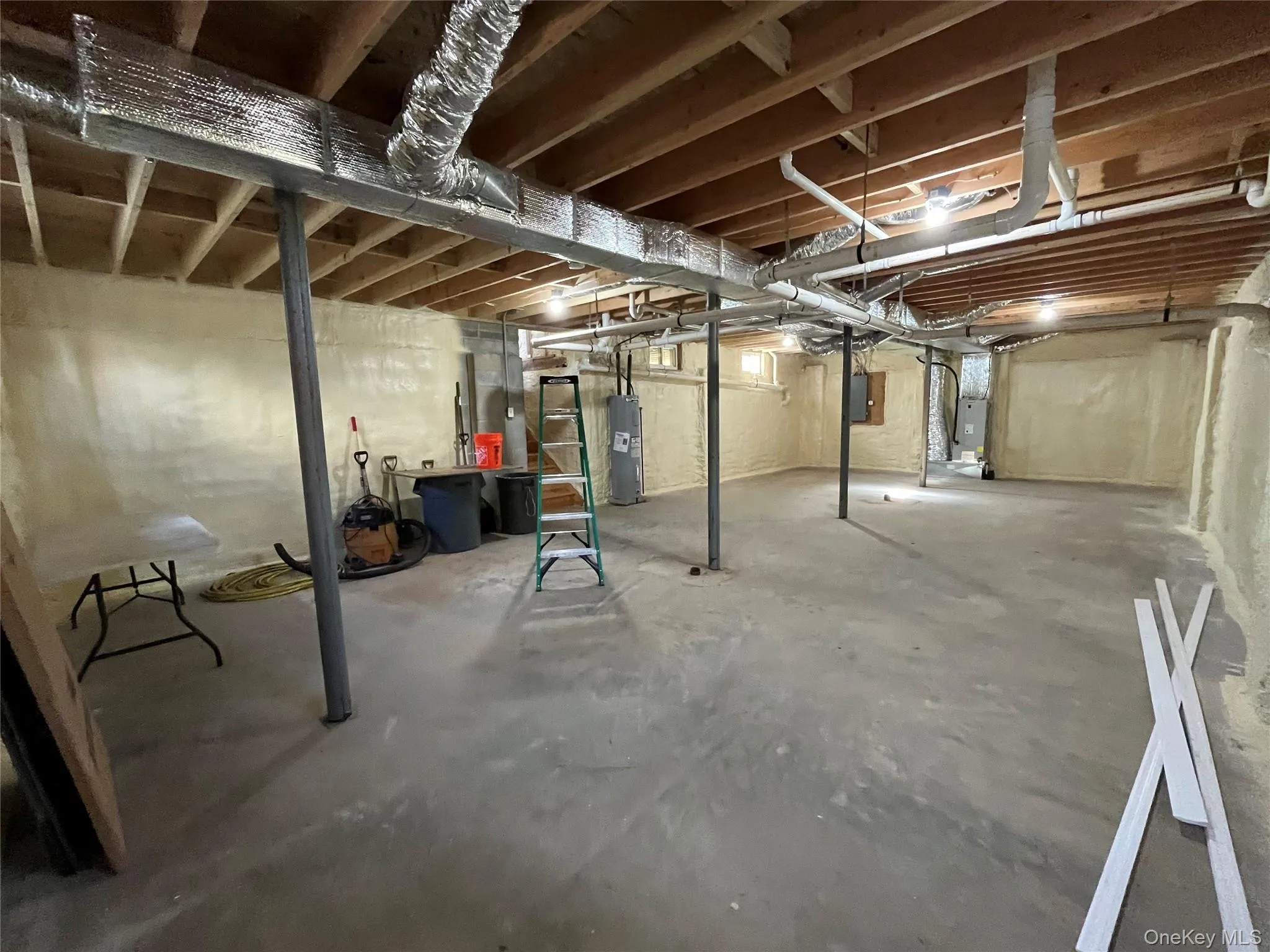 Unfinished basement with water heater and heating unit Unfinished basement with water heater and heating unit