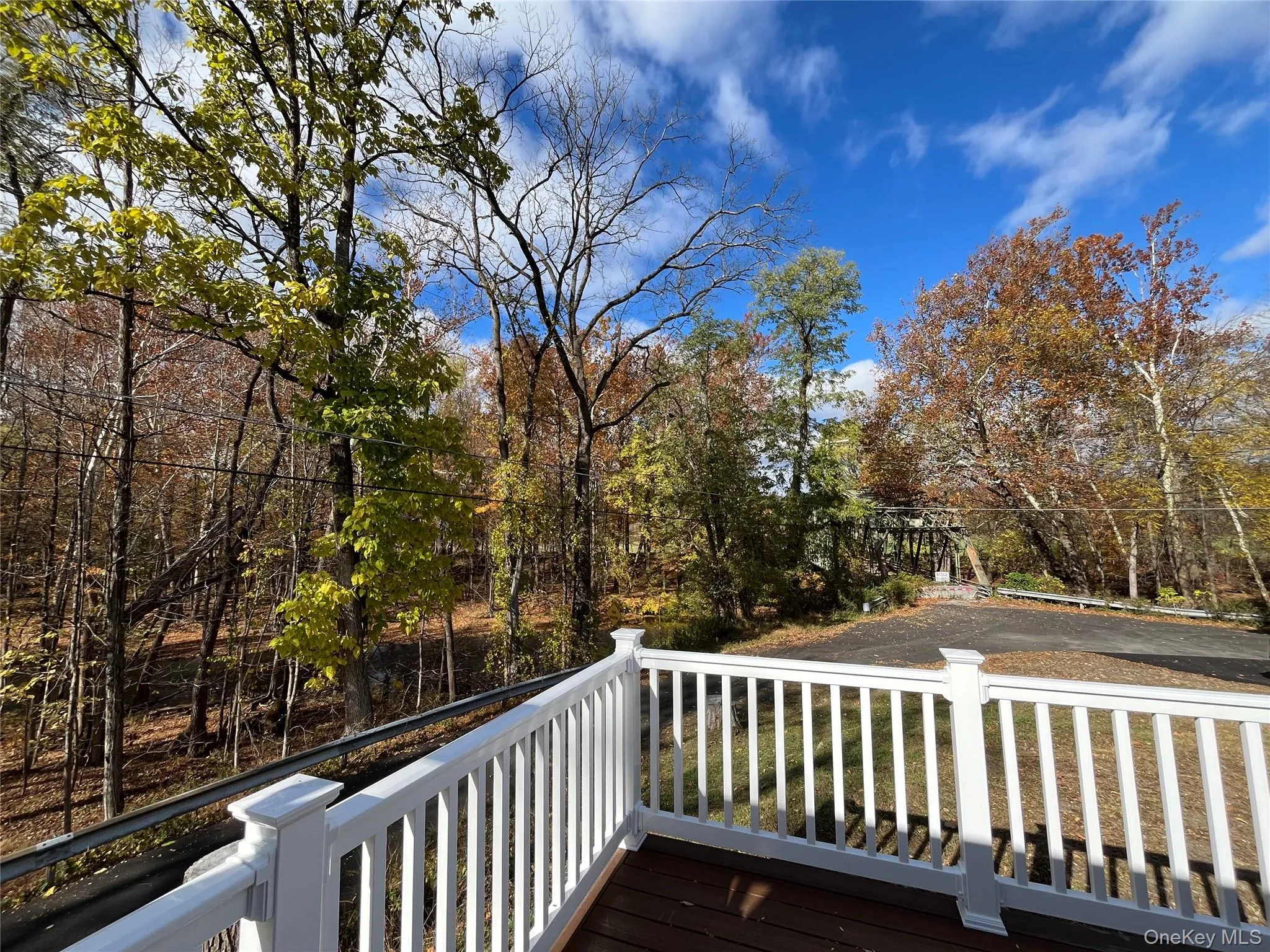 Wooden deck featuring view of wooded area Wooden deck featuring view of wooded area