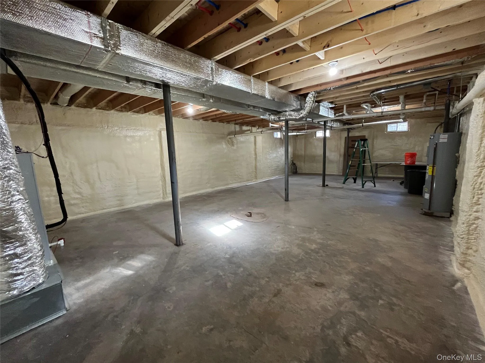 Below grade area featuring water heater Below grade area featuring water heater