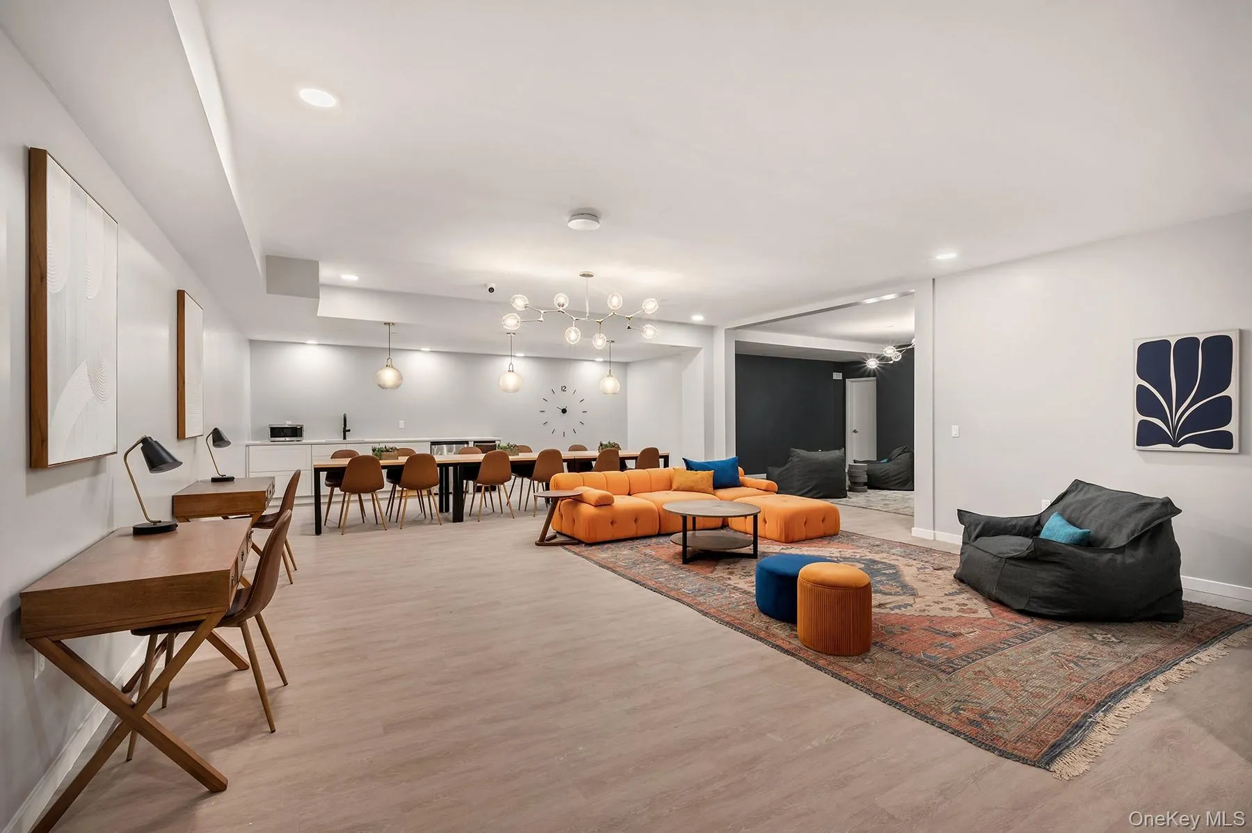 Living area with light wood-style floors and recessed lighting Living area with light wood-style floors and recessed lighting