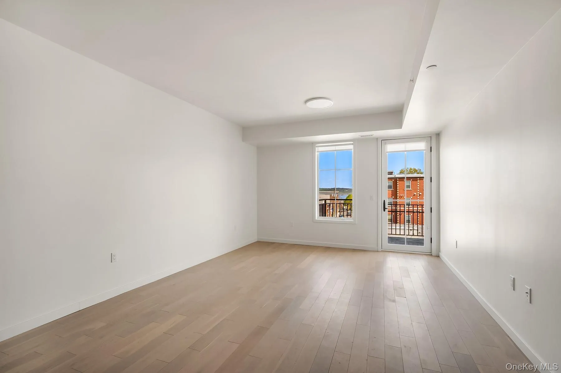 Spare room with baseboards and light wood-style floors Spare room with baseboards and light wood-style floors