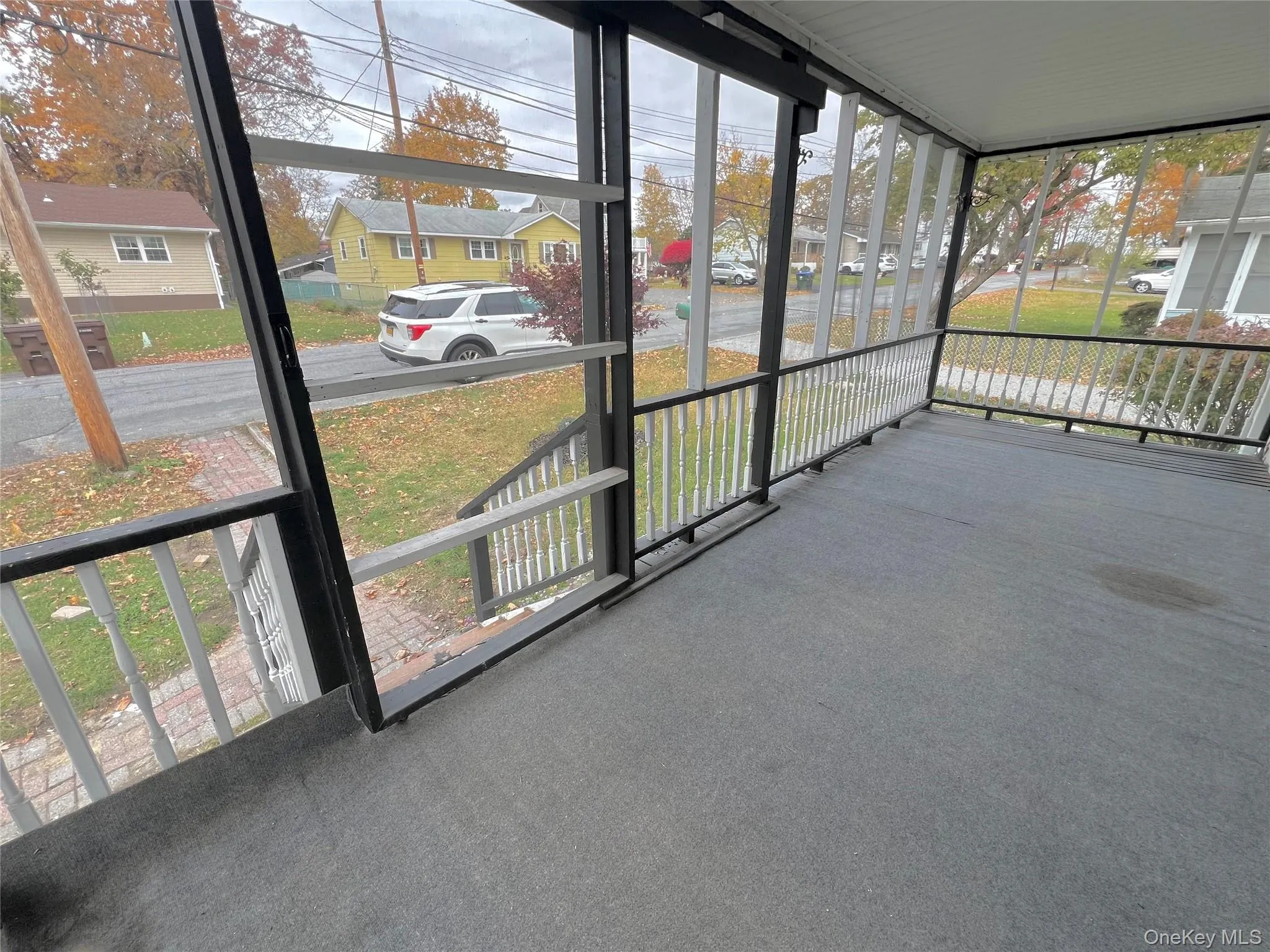 Unfurnished sunroom featuring healthy amount of natural light, a residential view, and a porch Unfurnished sunroom featuring healthy amount of natural light, a residential view, and a porch