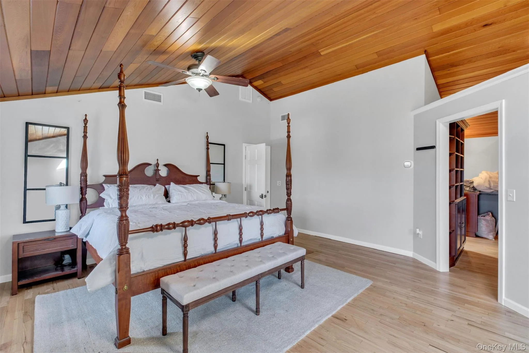 Bedroom with vaulted ceiling, light wood-type flooring, wooden ceiling, and a ceiling fan Bedroom with vaulted ceiling, light wood-type flooring, wooden ceiling, and a ceiling fan