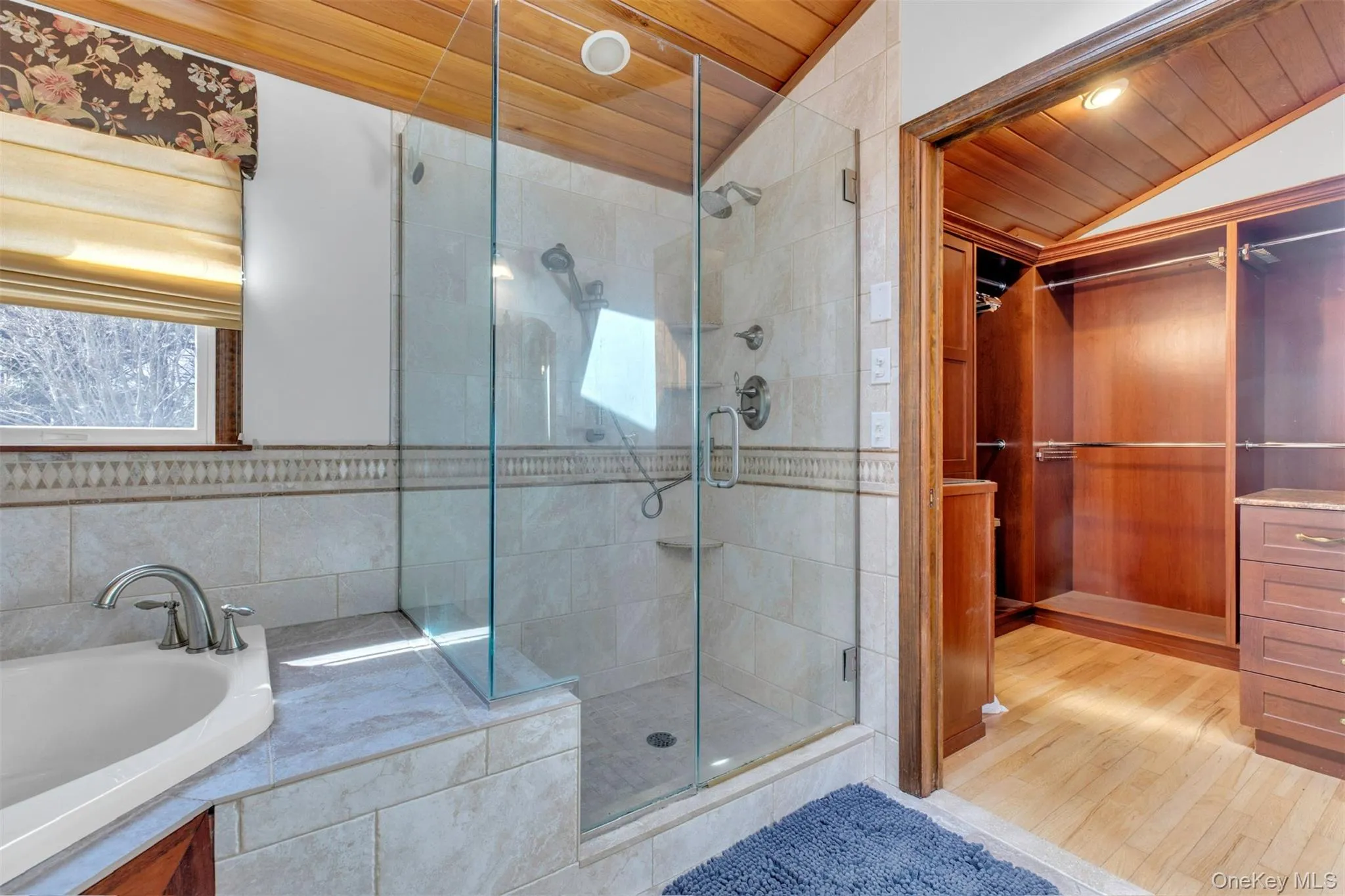 Bathroom with wood ceiling, a garden tub, a sauna / steam room, a shower stall, and light wood finished floors Bathroom with wood ceiling, a garden tub, a sauna / steam room, a shower stall, and light wood finished floors