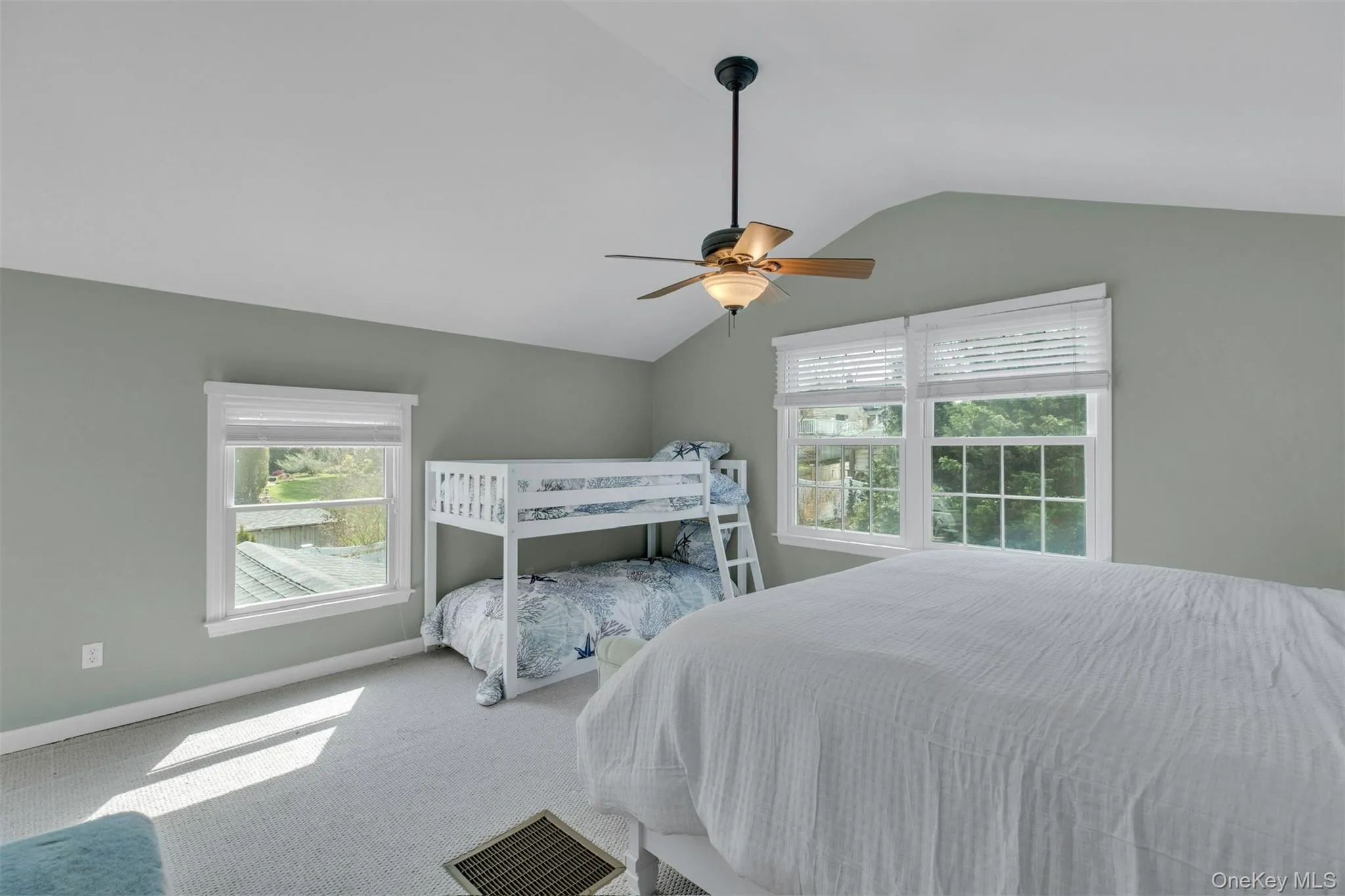 Carpeted bedroom with vaulted ceiling and ceiling fan Carpeted bedroom with vaulted ceiling and ceiling fan