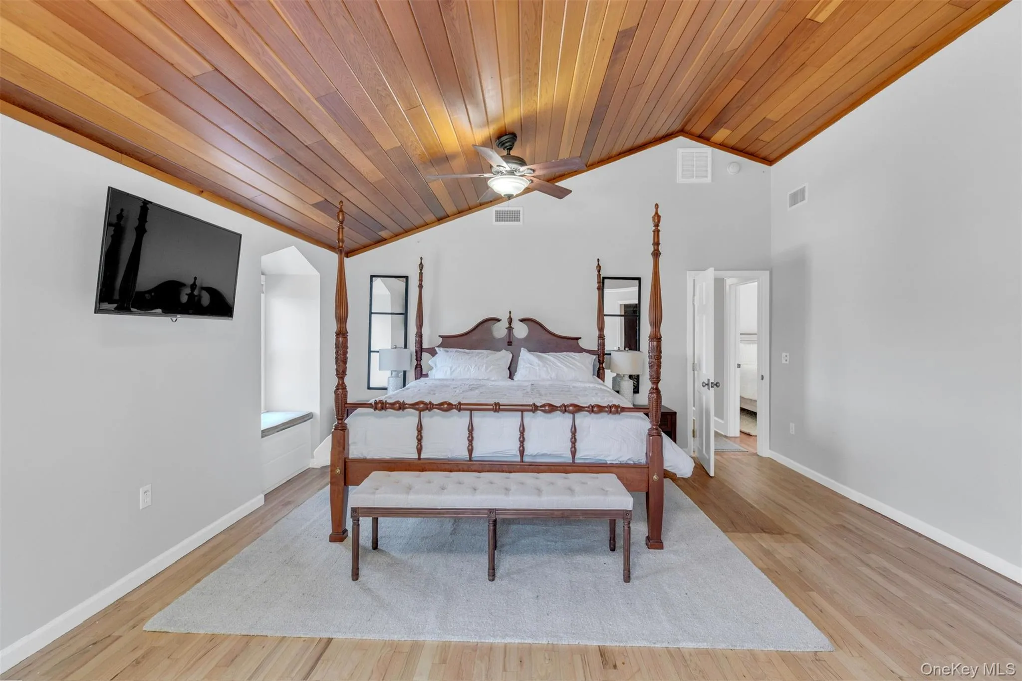 Bedroom featuring vaulted ceiling, wood ceiling, ceiling fan, and light wood-style floors Bedroom featuring vaulted ceiling, wood ceiling, ceiling fan, and light wood-style floors