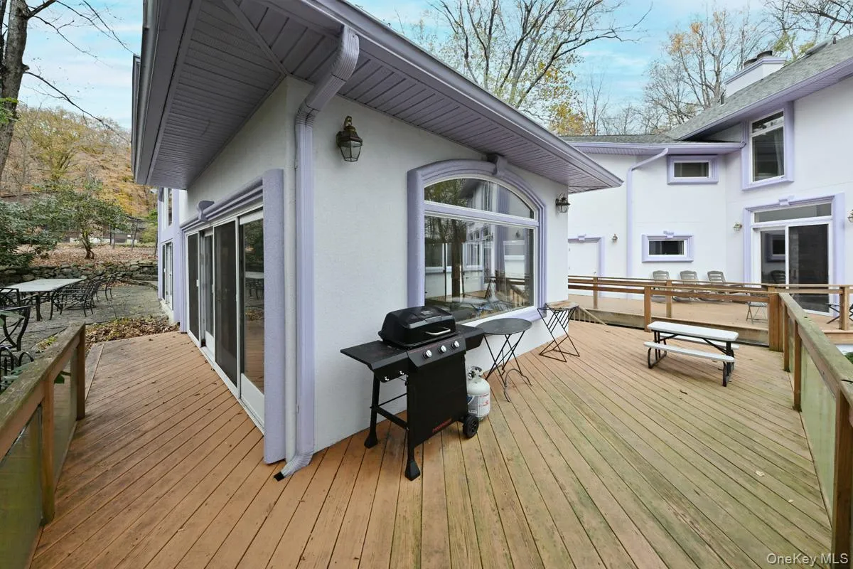 Deck featuring a grill and outdoor dining area Deck featuring a grill and outdoor dining area