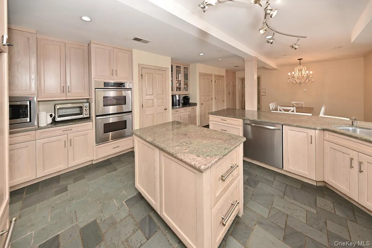 Kitchen featuring light brown cabinets, light stone counters, and recessed lighting Kitchen featuring light brown cabinets, light stone counters, and recessed lighting