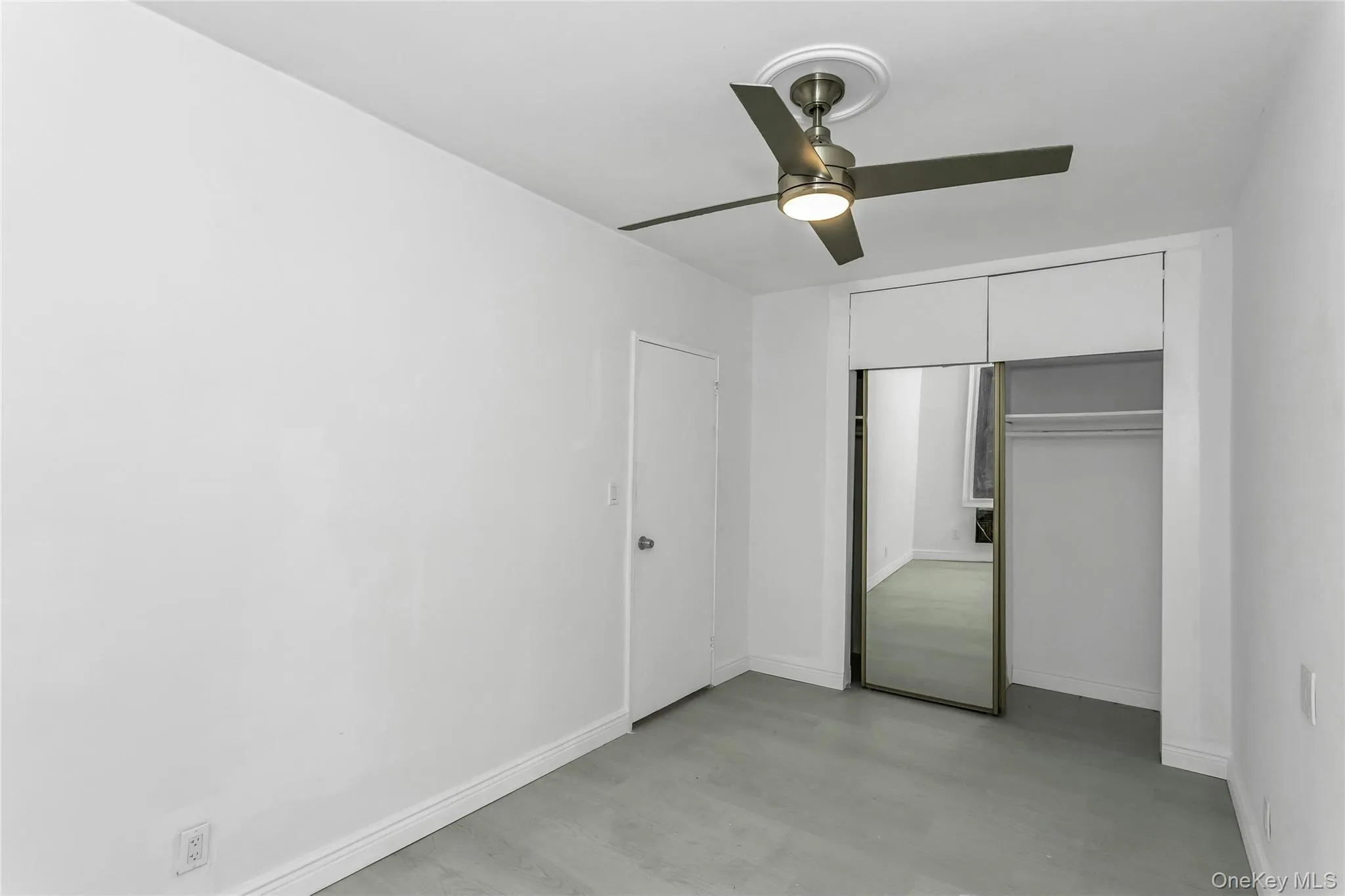 Unfurnished bedroom with a ceiling fan, a closet, and light wood-type flooring Unfurnished bedroom with a ceiling fan, a closet, and light wood-type flooring