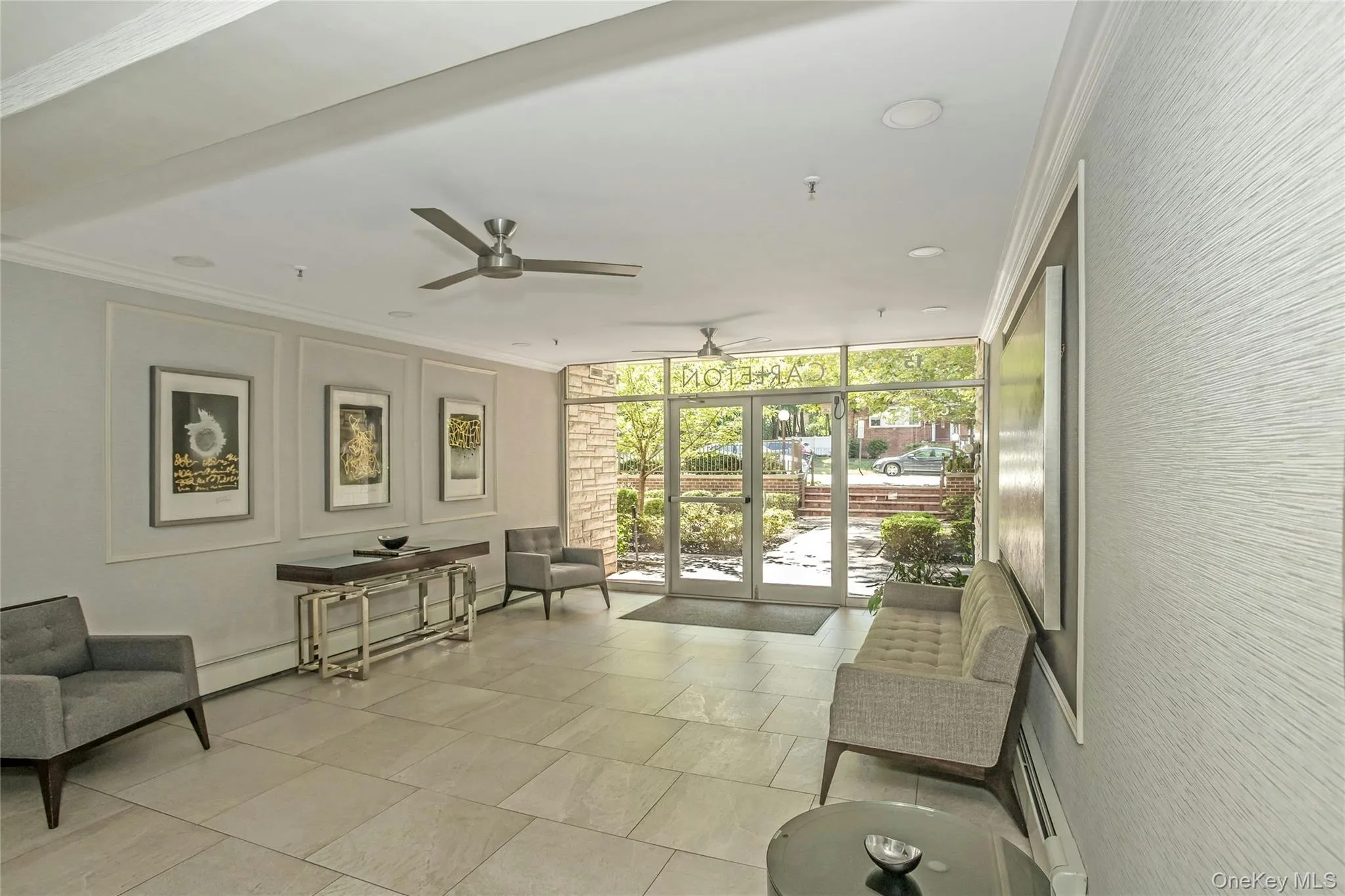 Common area featuring a wall of windows, crown molding, a decorative wall, and recessed lighting Common area featuring a wall of windows, crown molding, a decorative wall, and recessed lighting