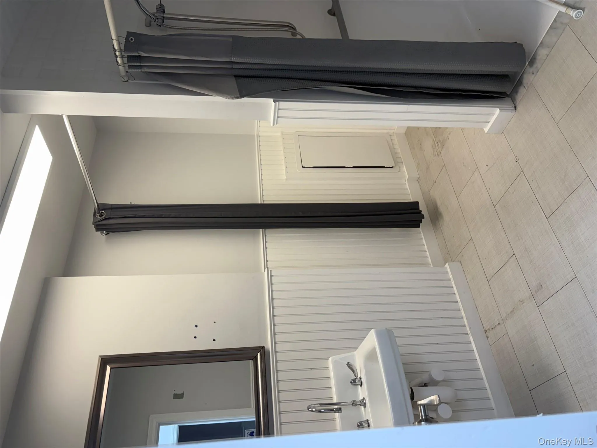 Full bath with wainscoting and a shower stall Full bath with wainscoting and a shower stall